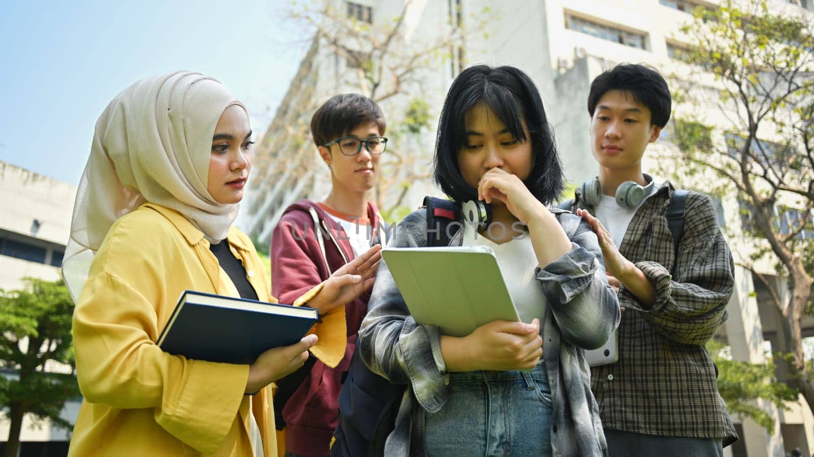 Supporting group of university students comforting their sad female friend. Friendship, support and youth lifestyle concept by prathanchorruangsak