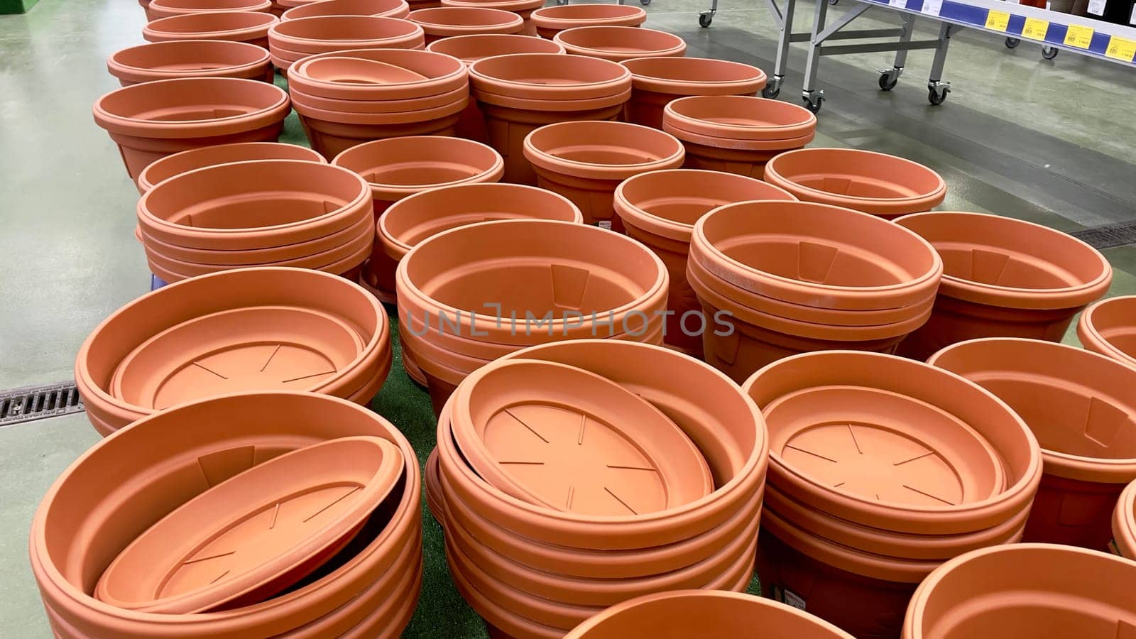 Close-up of empty flower pots in a store or greenhouse. Colorful pots for plants. Gardening and landscape design concept.