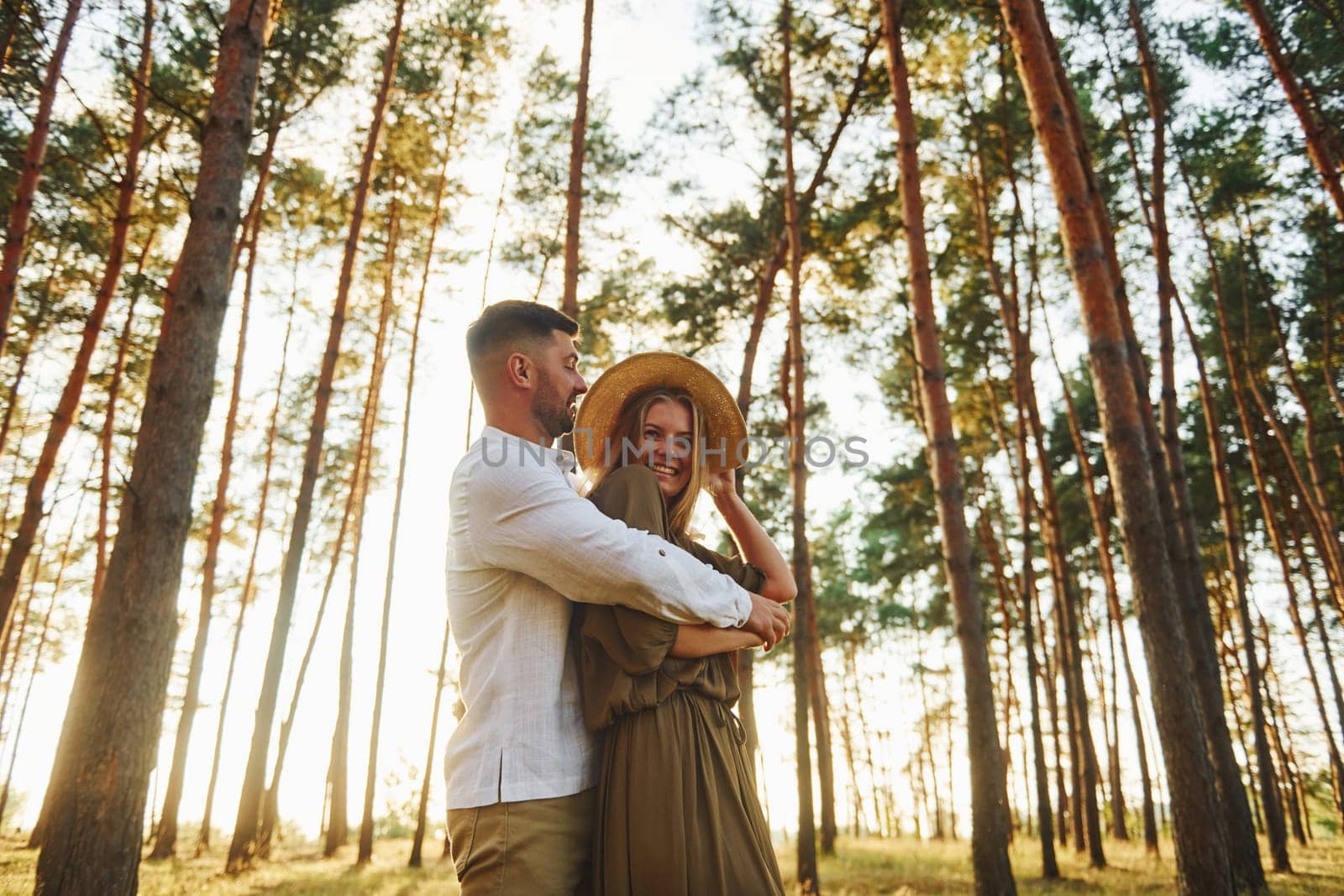 Weekend time spending. Happy couple is outdoors in the forest at daytime.