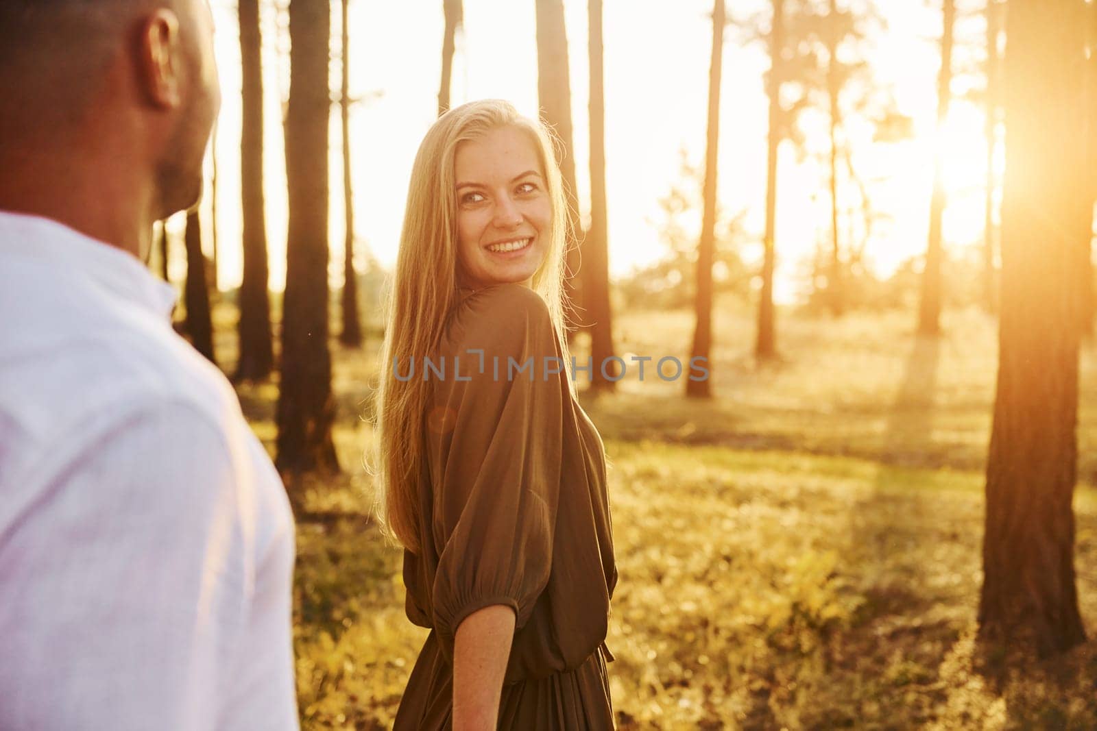 Tenderness and hapiness. Couple is outdoors in the forest at daytime.