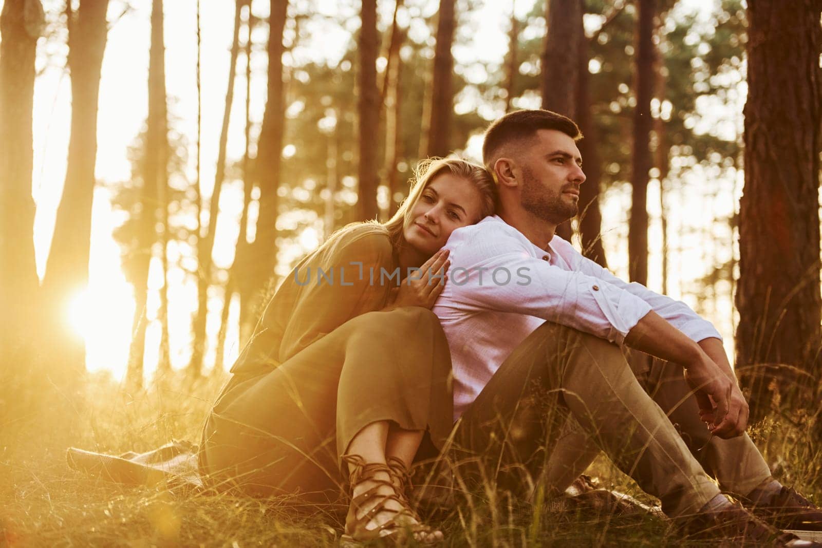 Resting in the forest. Happy couple is outdoors at daytime.