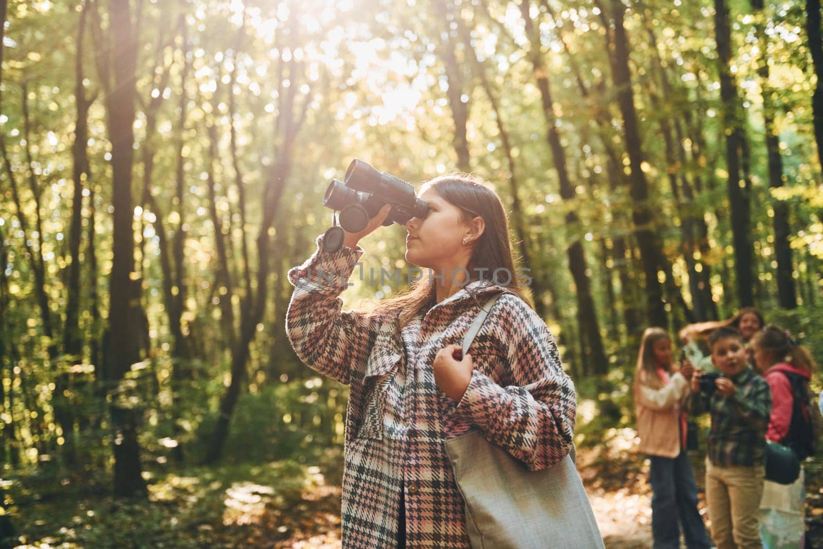 Discovering new places. Kids in green forest at summer daytime together by Standret