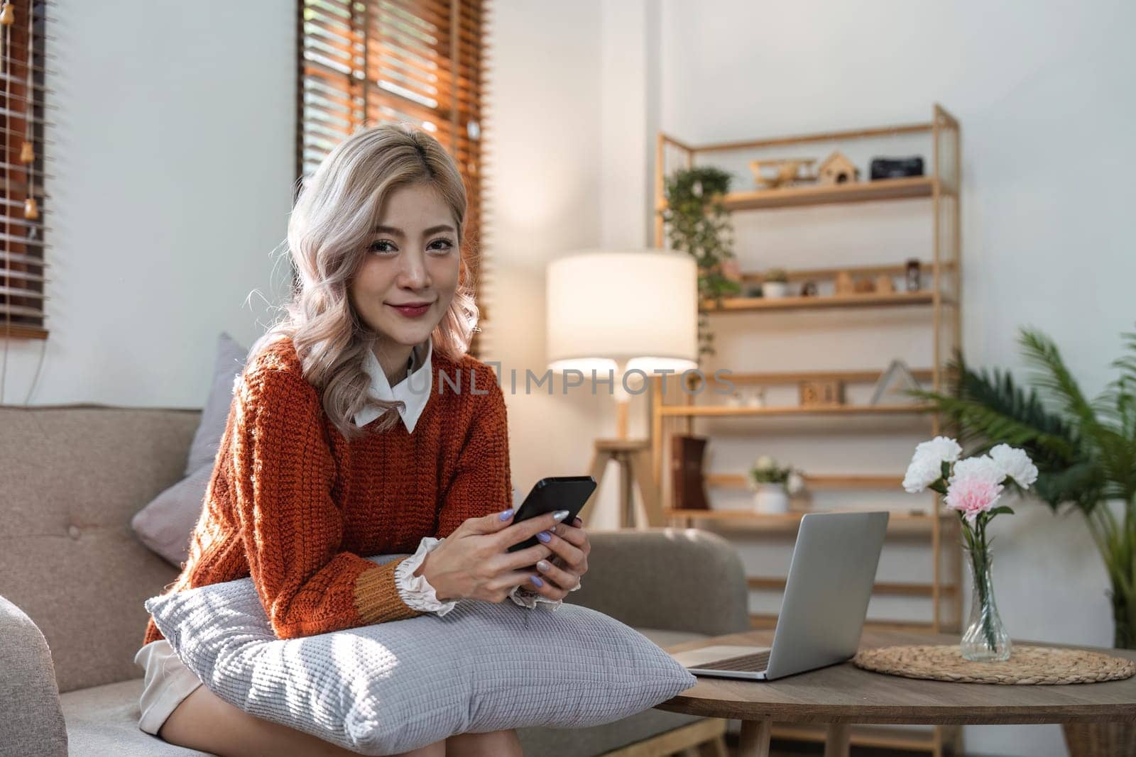 woman beautiful happy young woman resting on comfortable sofa, using cellphone application, web surfing useful information, playing games, shopping online.