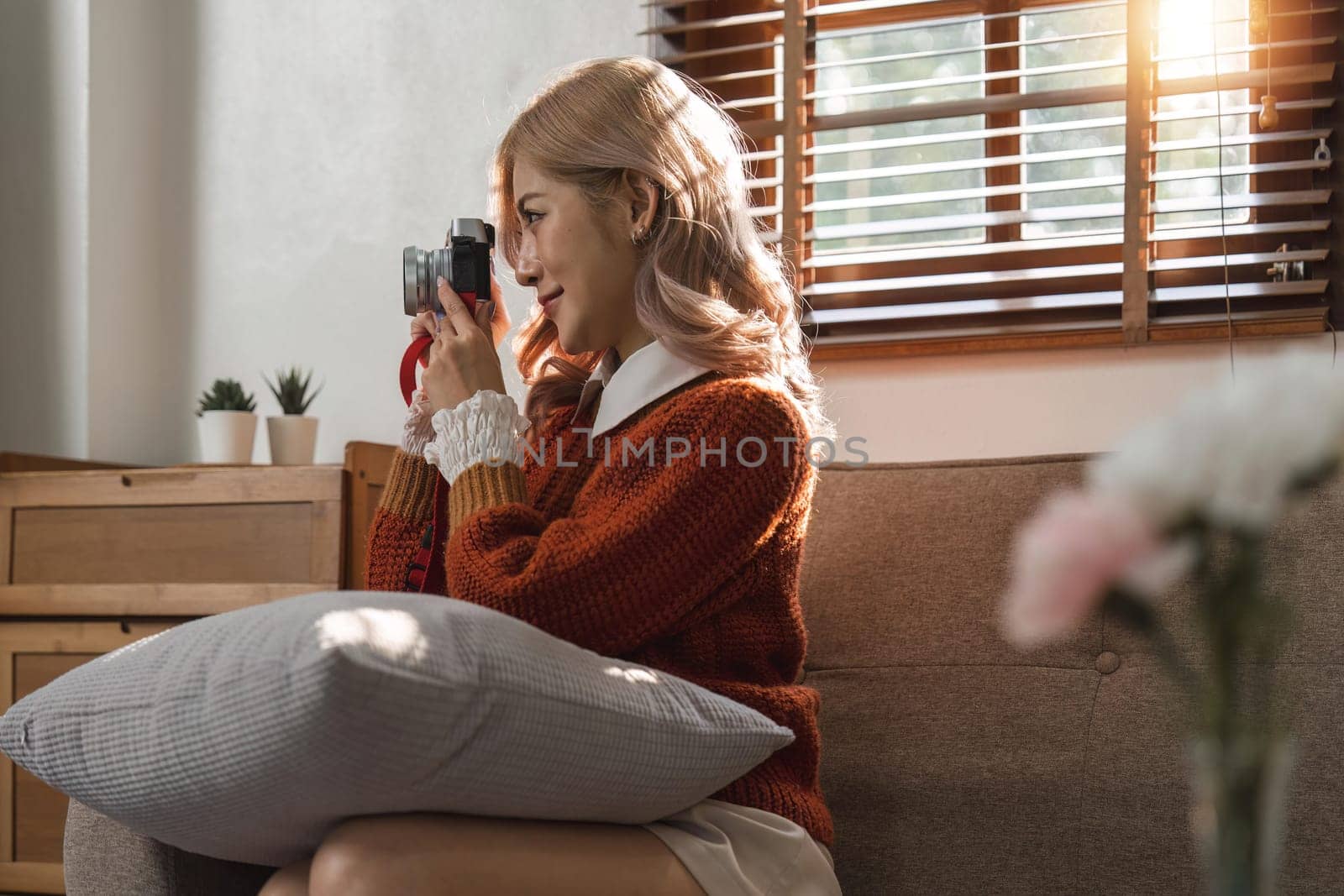 Portrait of pretty young woman taking picture on camera.