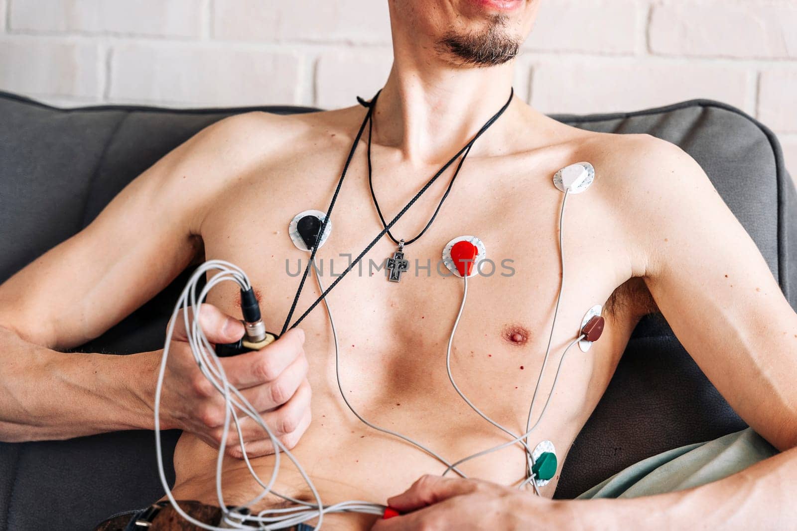 A man wearing portable holter monitor device. Recording cardiogram for 24 hours. Arrhythmia. diagnosis of cardiac activity. prevention, monitoring, heart problems