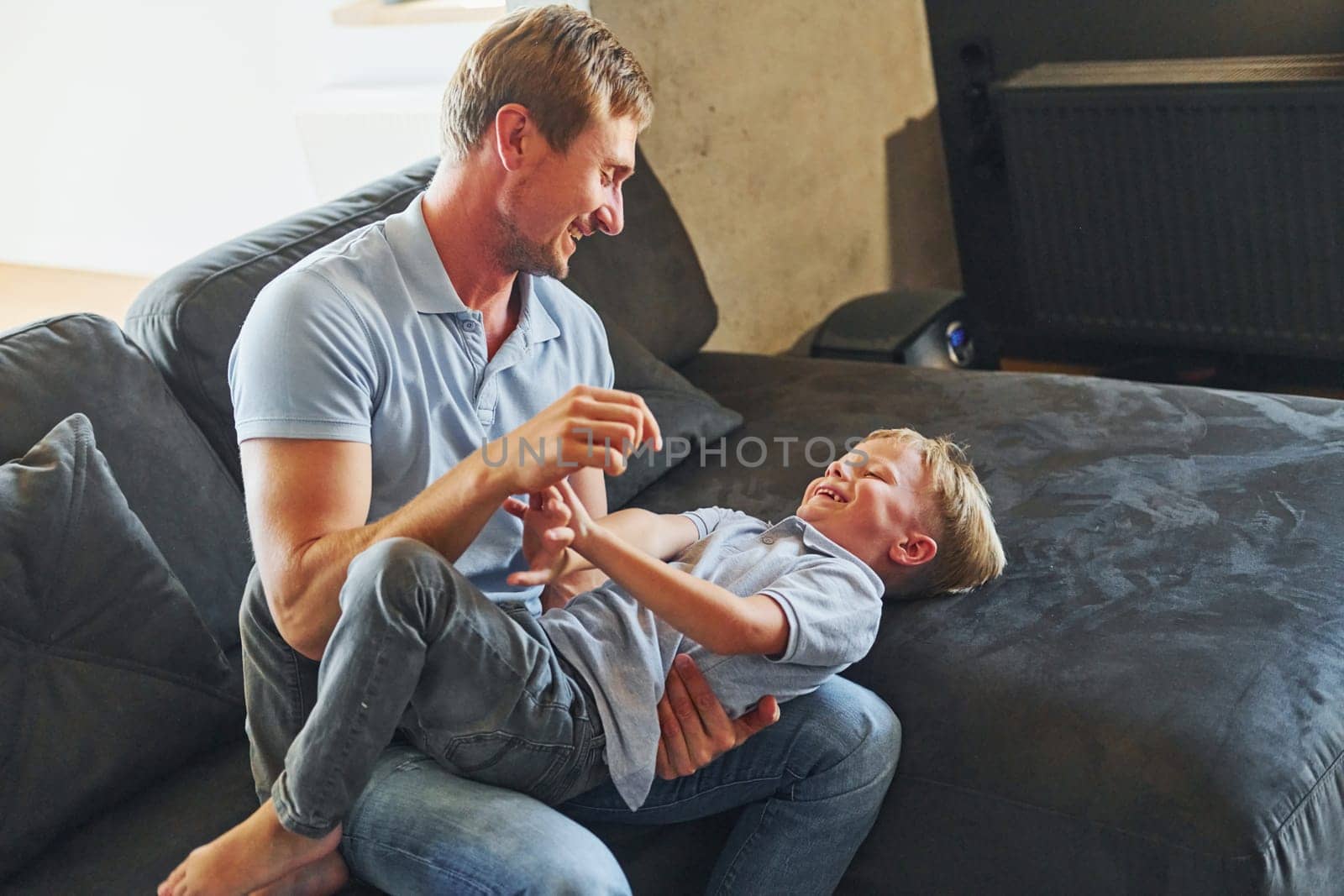 Positive emotions. Father and son is indoors at home together.