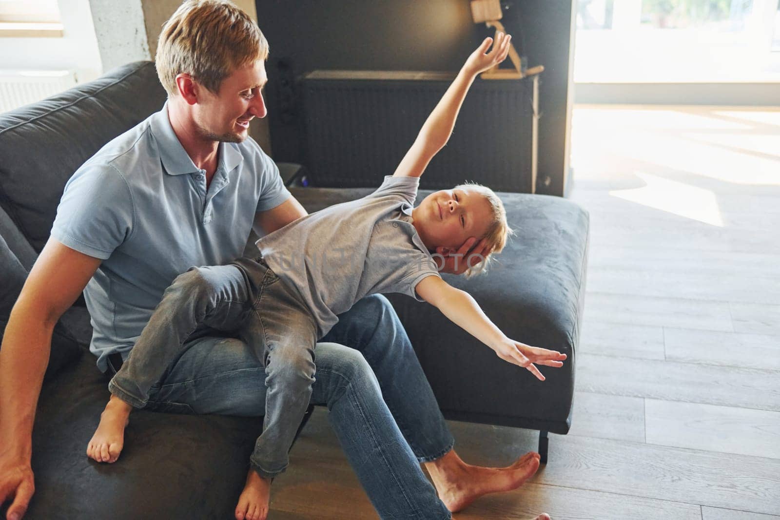 Positive emotions. Father and son is indoors at home together.