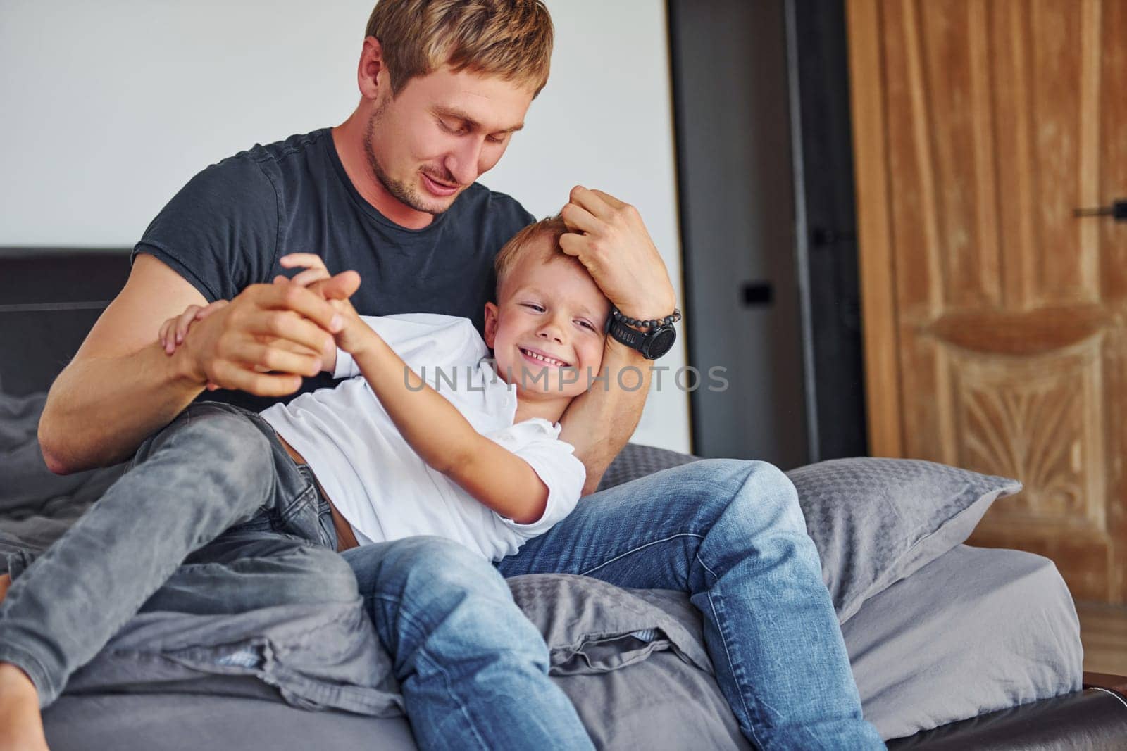 Happy parent. Father and son is indoors at home together.
