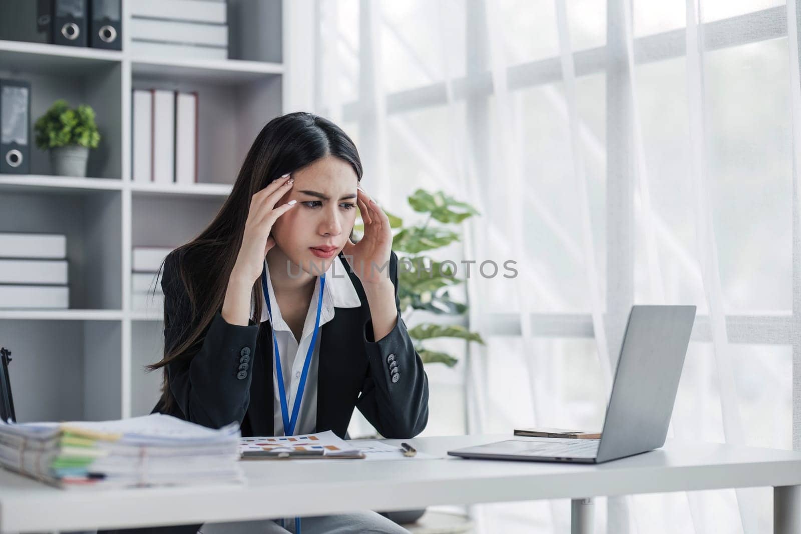 asian woman thinking hard concerned about online problem solution looking at laptop screen, worried serious asian businesswoman focused on solving difficult work computer task...