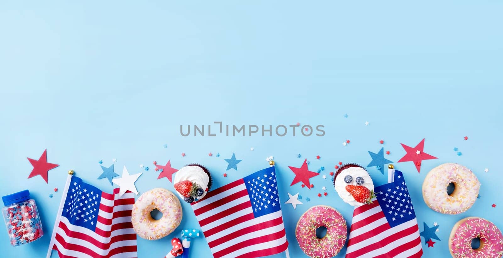 Fourth of july celebration. Sweet cupcakes and donuts with usa flag on blue background