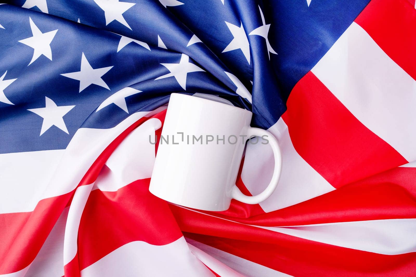 Blank white cup for mockup design over USA flag background by Desperada