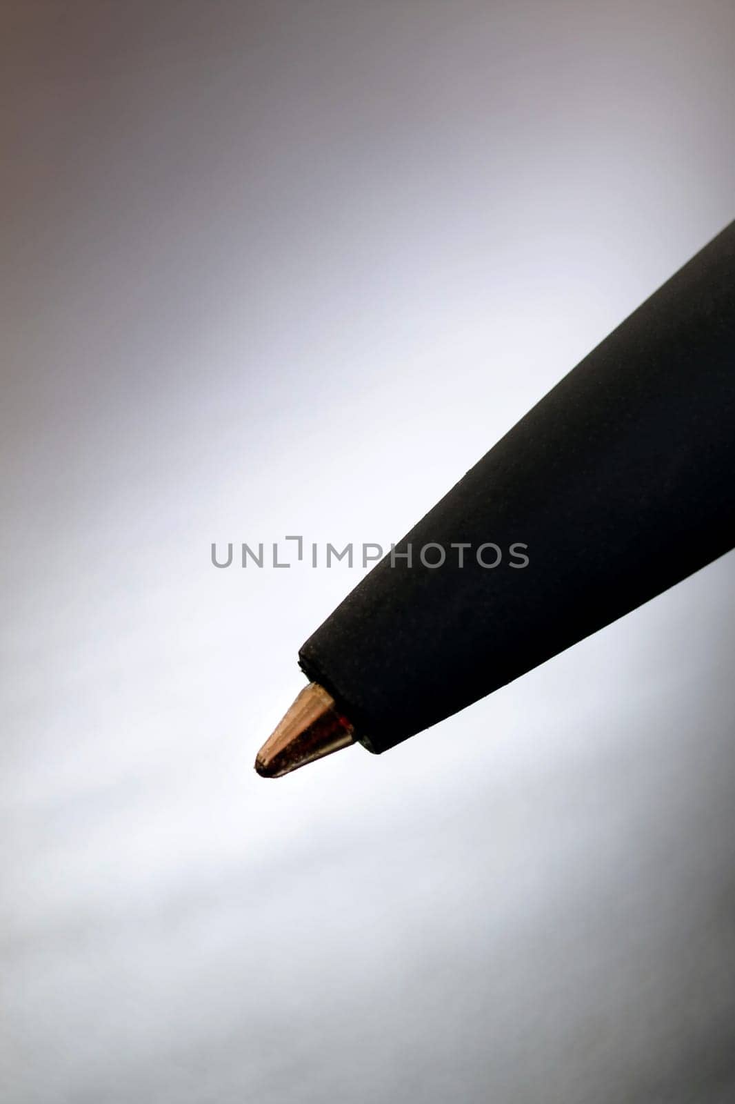 Black pen on a black wooden table copy space