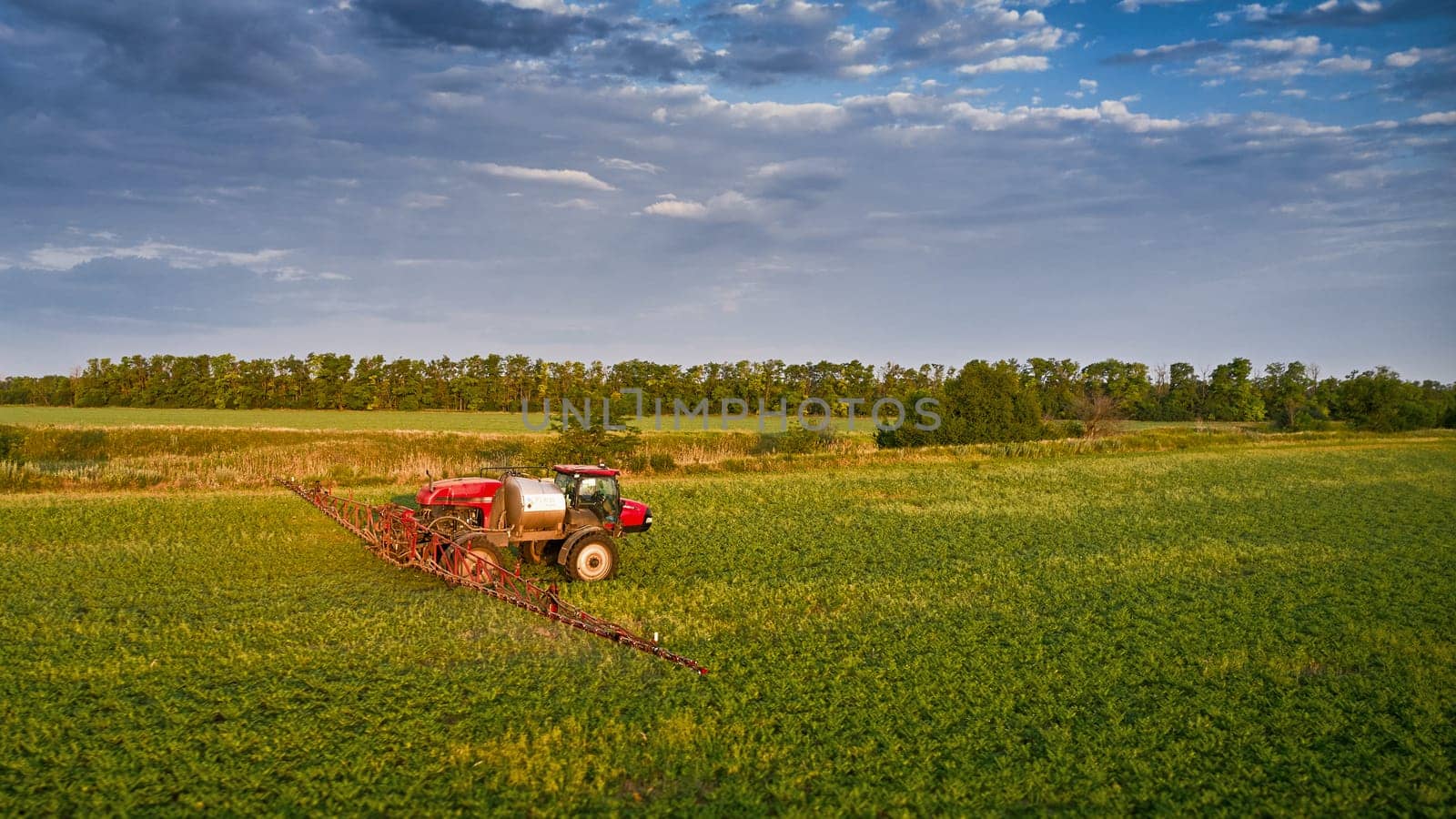 Sprayer CASE 3330 spraying pesticides on chickpea field. Field treatment with chemicals against pests, insects and plant diseases. Taking care of the Crop. 21.06.22, Rostov area. Russia