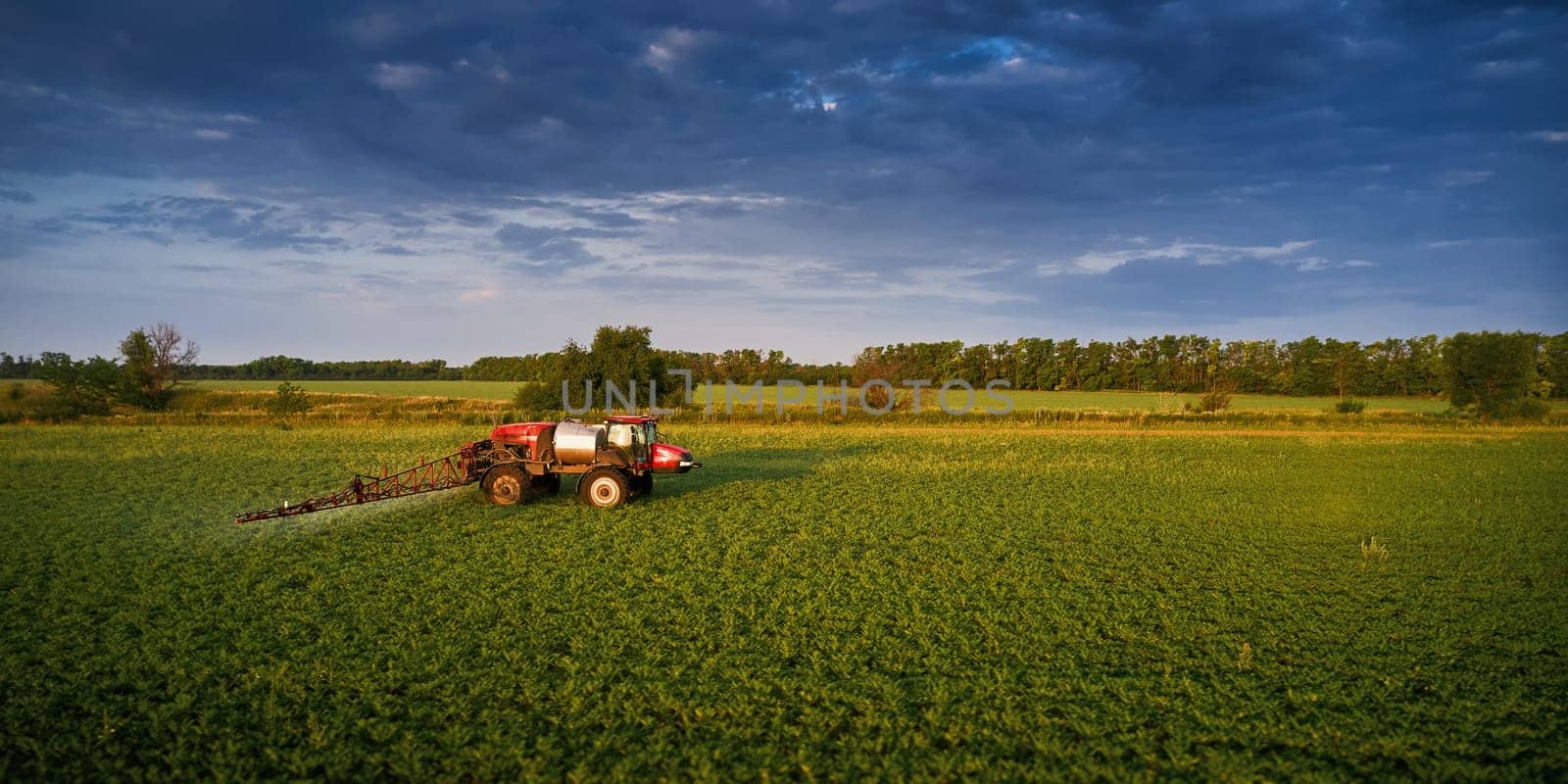 Sprayer CASE 3330 spraying pesticides on chickpea field. Field treatment with chemicals against pests, insects and plant diseases. Taking care of the Crop. 21.06.22, Rostov area. Russia