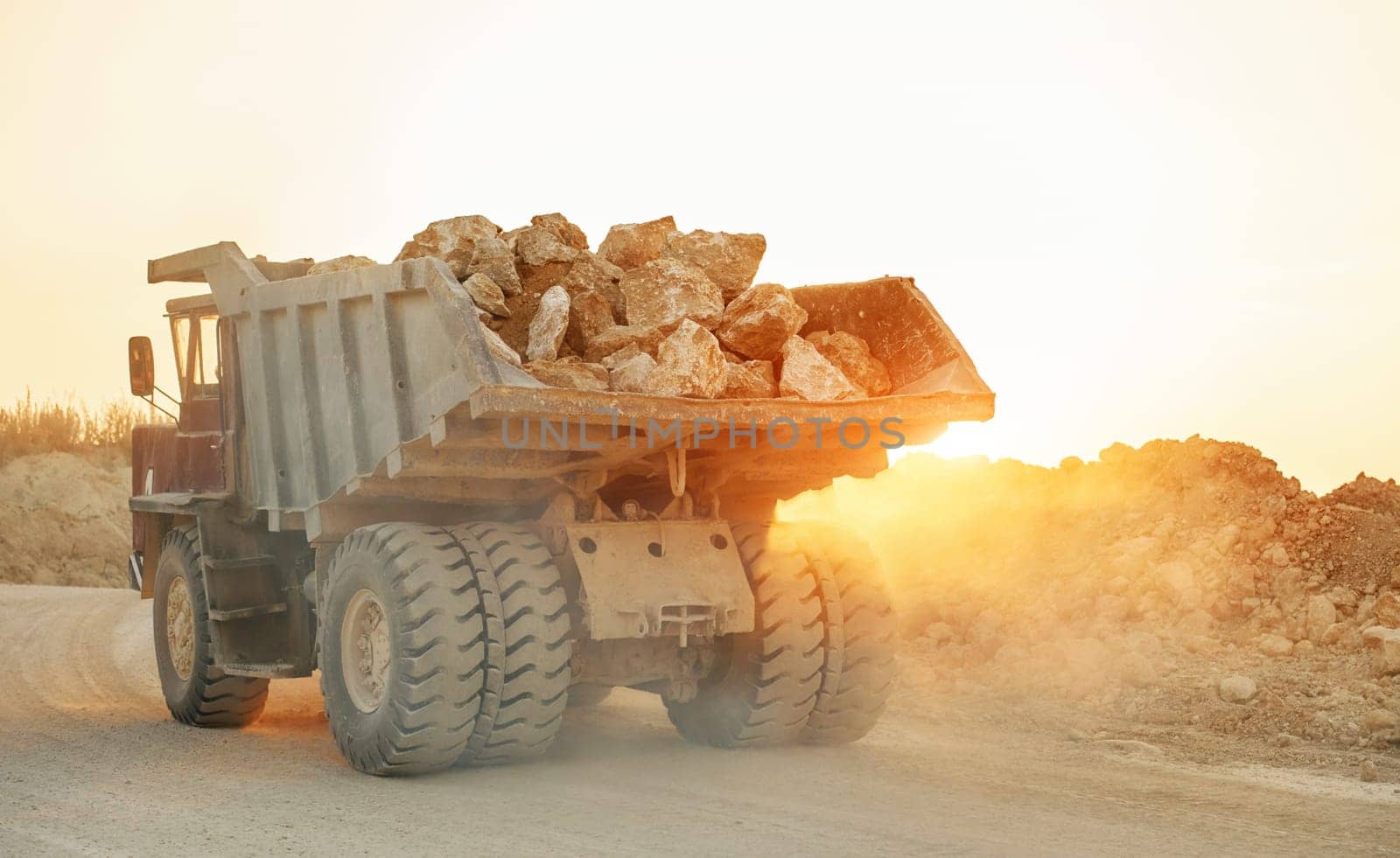 Beautiful sunshine. Loading vehicle is outdoors on the borrow pit at daytime. No people.