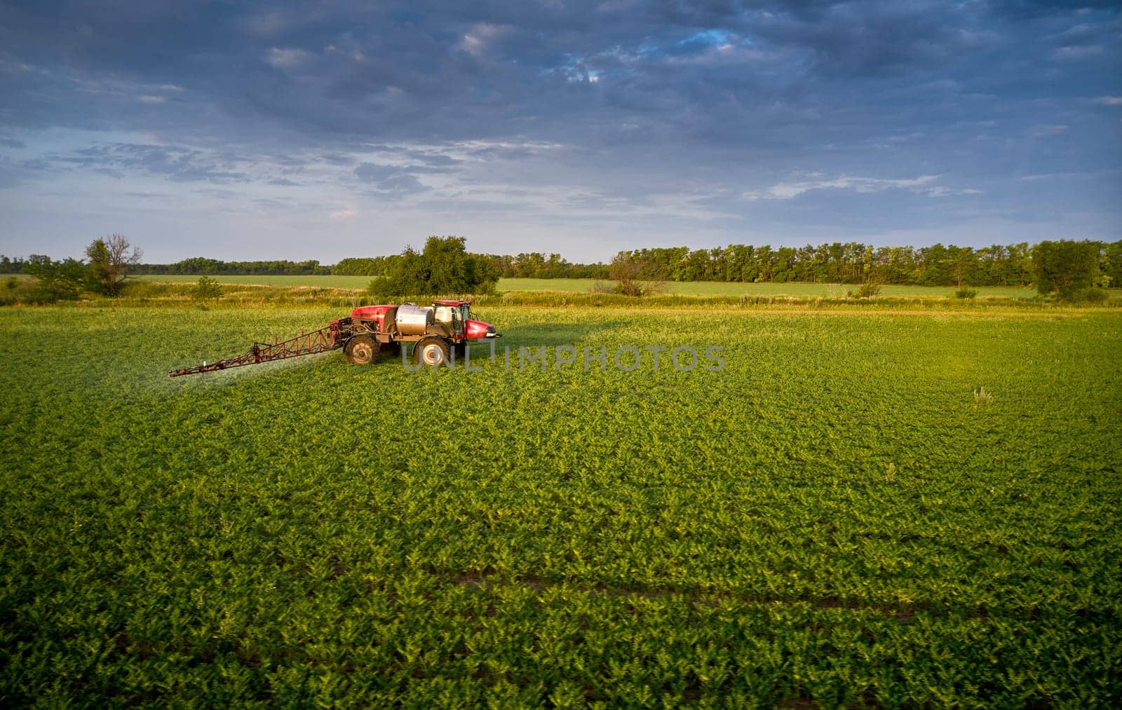 Sprayer CASE 3330 spraying pesticides on chickpea field. Field treatment with chemicals against pests, insects and plant diseases. Taking care of the Crop. 21.06.22, Rostov area. Russia