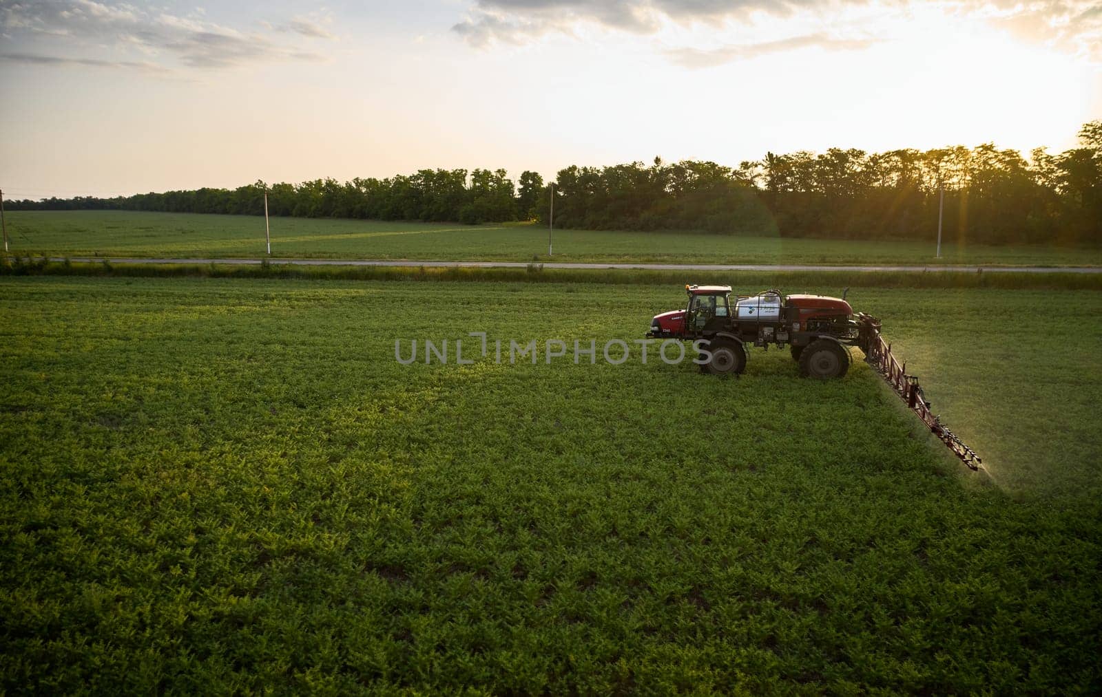 Sprayer CASE 3330 spraying pesticides on chickpea field. Field treatment with chemicals against pests, insects and plant diseases. Taking care of the Crop. 21.06.22, Rostov area. Russia