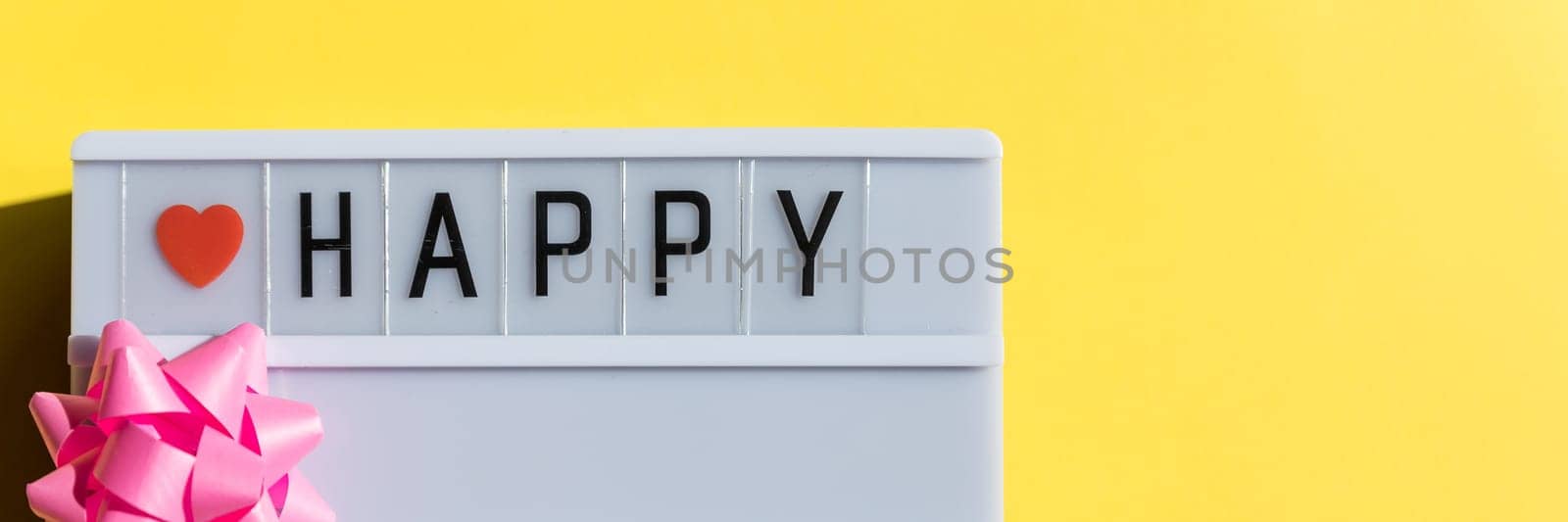 Happy day sign on light box on yellow backround.Happy Parents Day or International Day of Families.greeting card. Invitation for wedding.Stylish text frame lightbox with the inscription. web banner by YuliaYaspe1979
