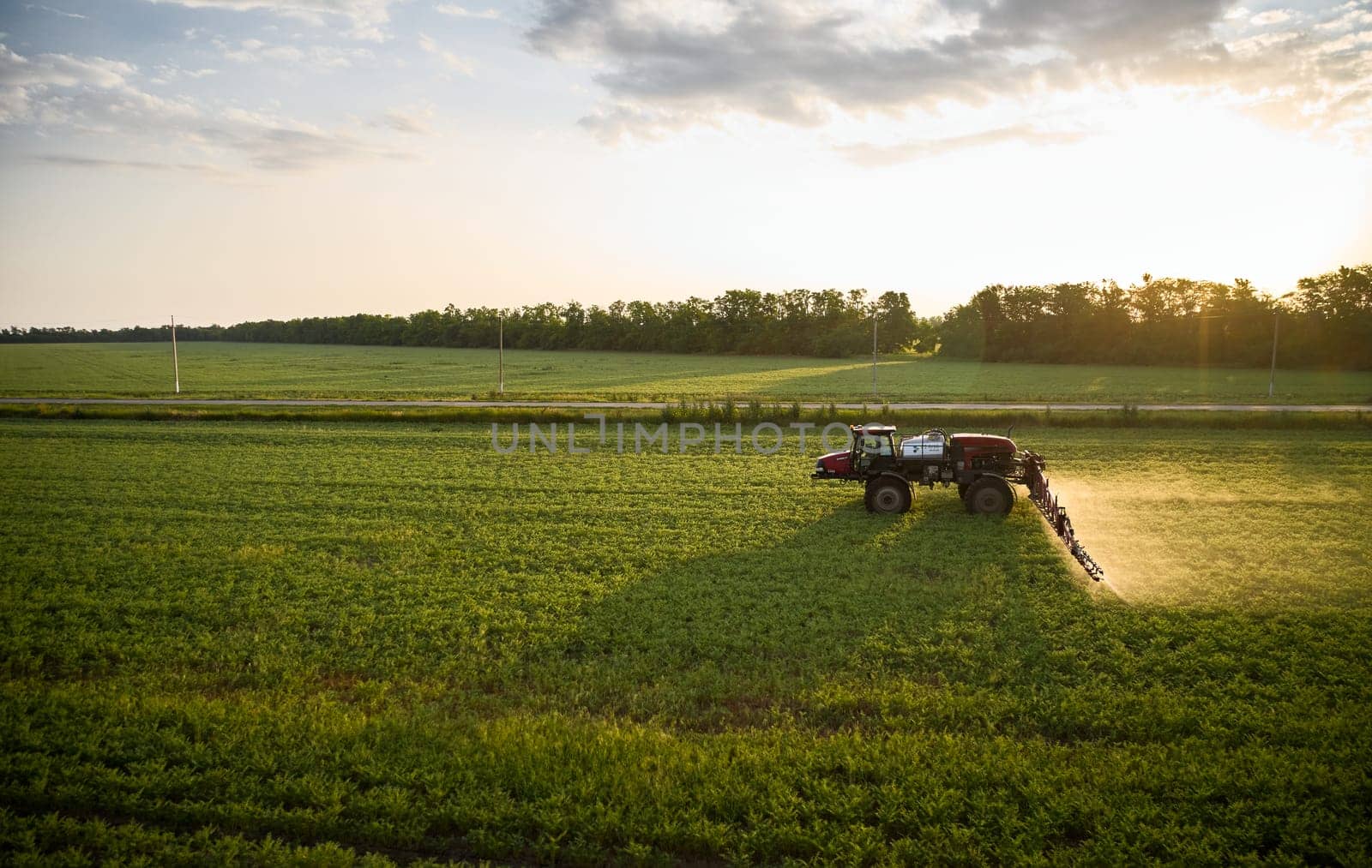 Sprayer CASE 3330 spraying pesticides on chickpea field. Field treatment with chemicals against pests, insects and plant diseases. Taking care of the Crop. 21.06.22, Rostov area. Russia