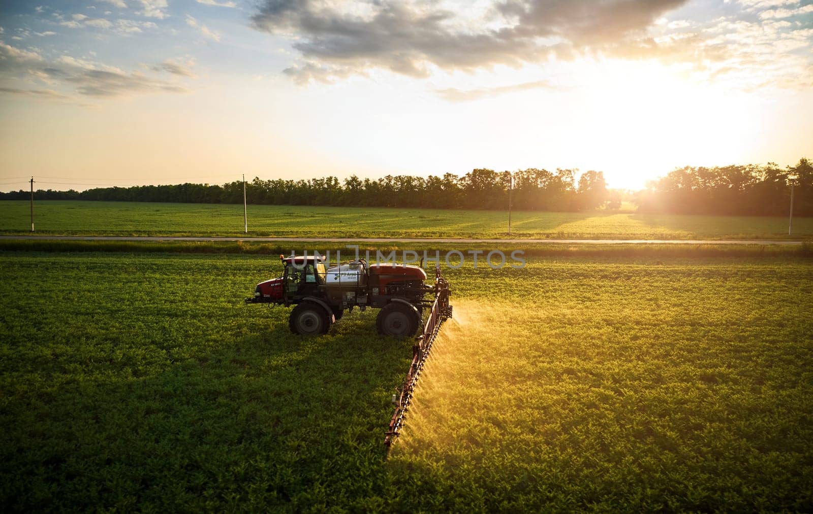 Sprayer CASE 3330 spraying pesticides on chickpea field. Field treatment with chemicals against pests, insects and plant diseases. Taking care of the Crop. 21.06.22, Rostov area. Russia