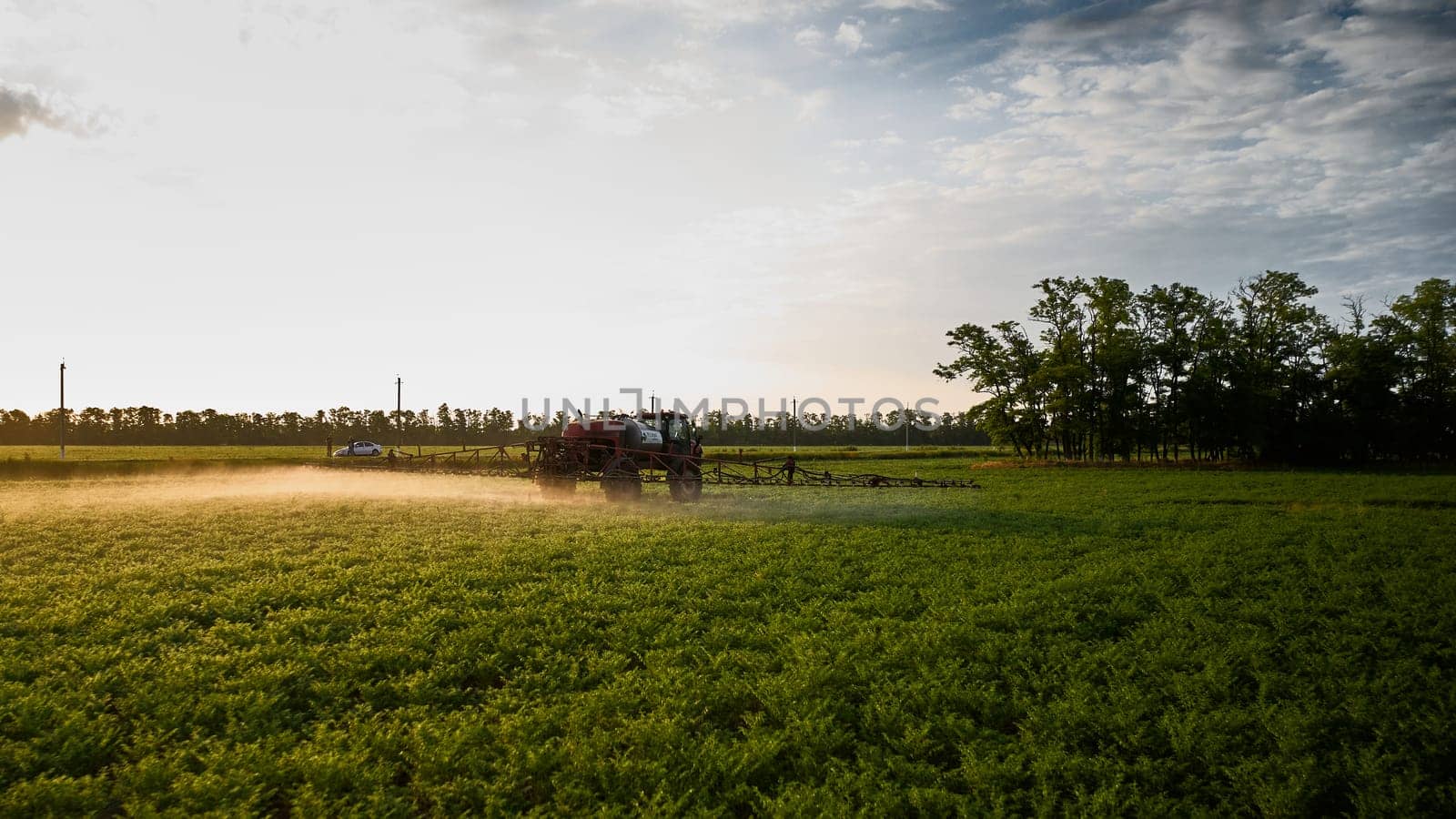 Sprayer CASE 3330 spraying pesticides on chickpea field. Field treatment with chemicals against pests, insects and plant diseases. Taking care of the Crop. 21.06.22, Rostov area. Russia