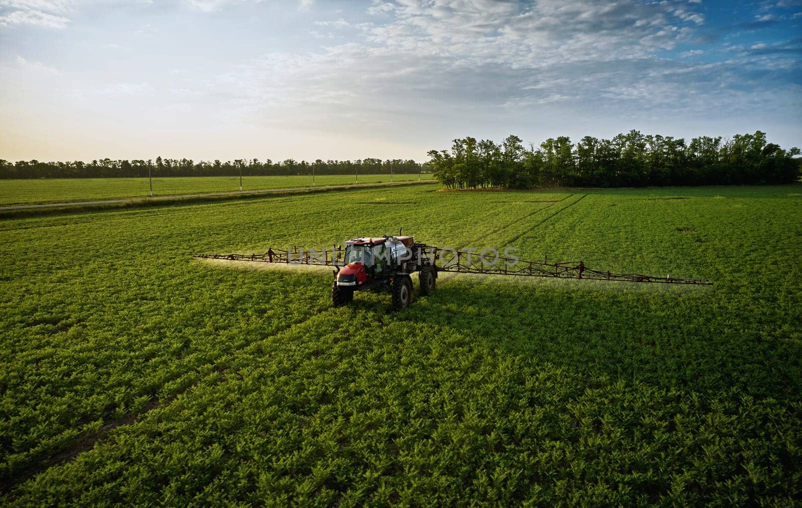Sprayer CASE 3330 spraying pesticides on chickpea field. Field treatment with chemicals against pests, insects and plant diseases. Taking care of the Crop. 21.06.22, Rostov area. Russia