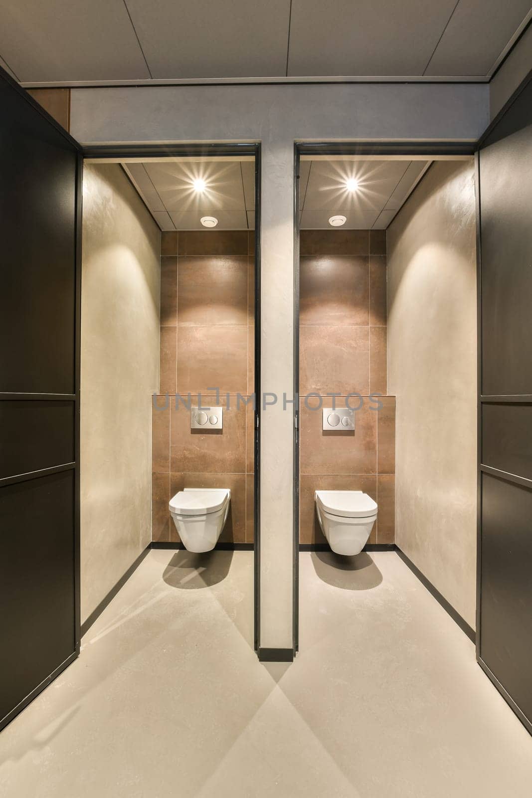 a public restroom with two toilets and a urinal by casamedia