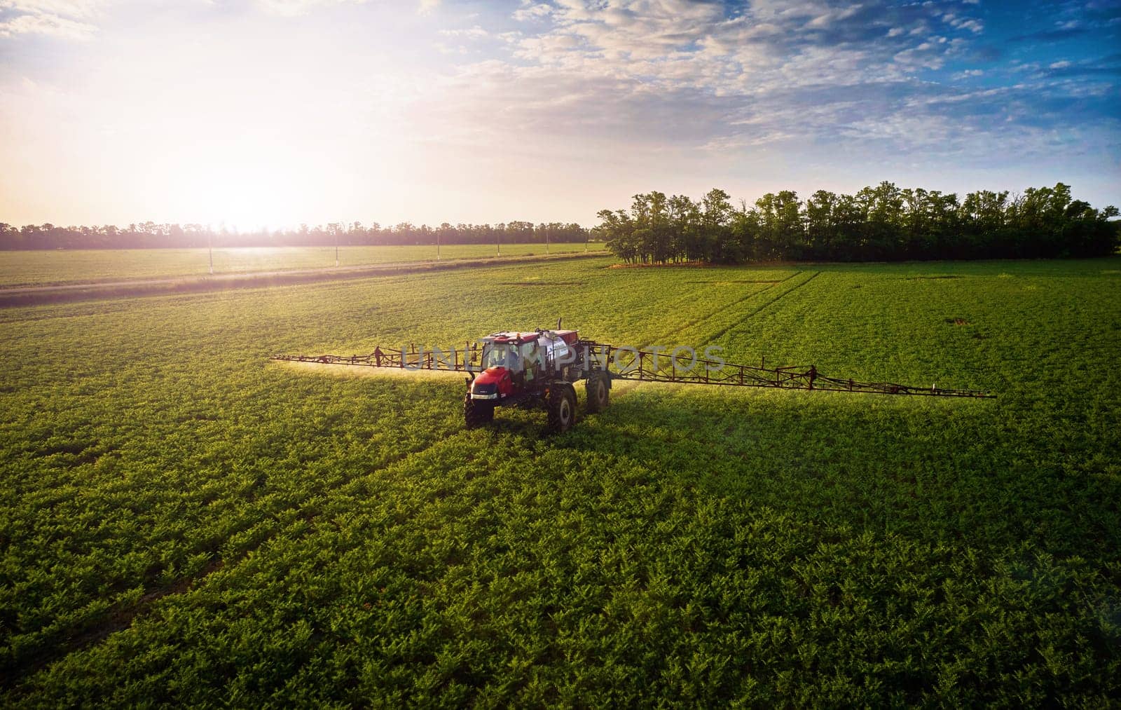 Sprayer CASE 3330 spraying pesticides on chickpea field. Field treatment with chemicals against pests, insects and plant diseases. Taking care of the Crop. 21.06.22, Rostov area. Russia