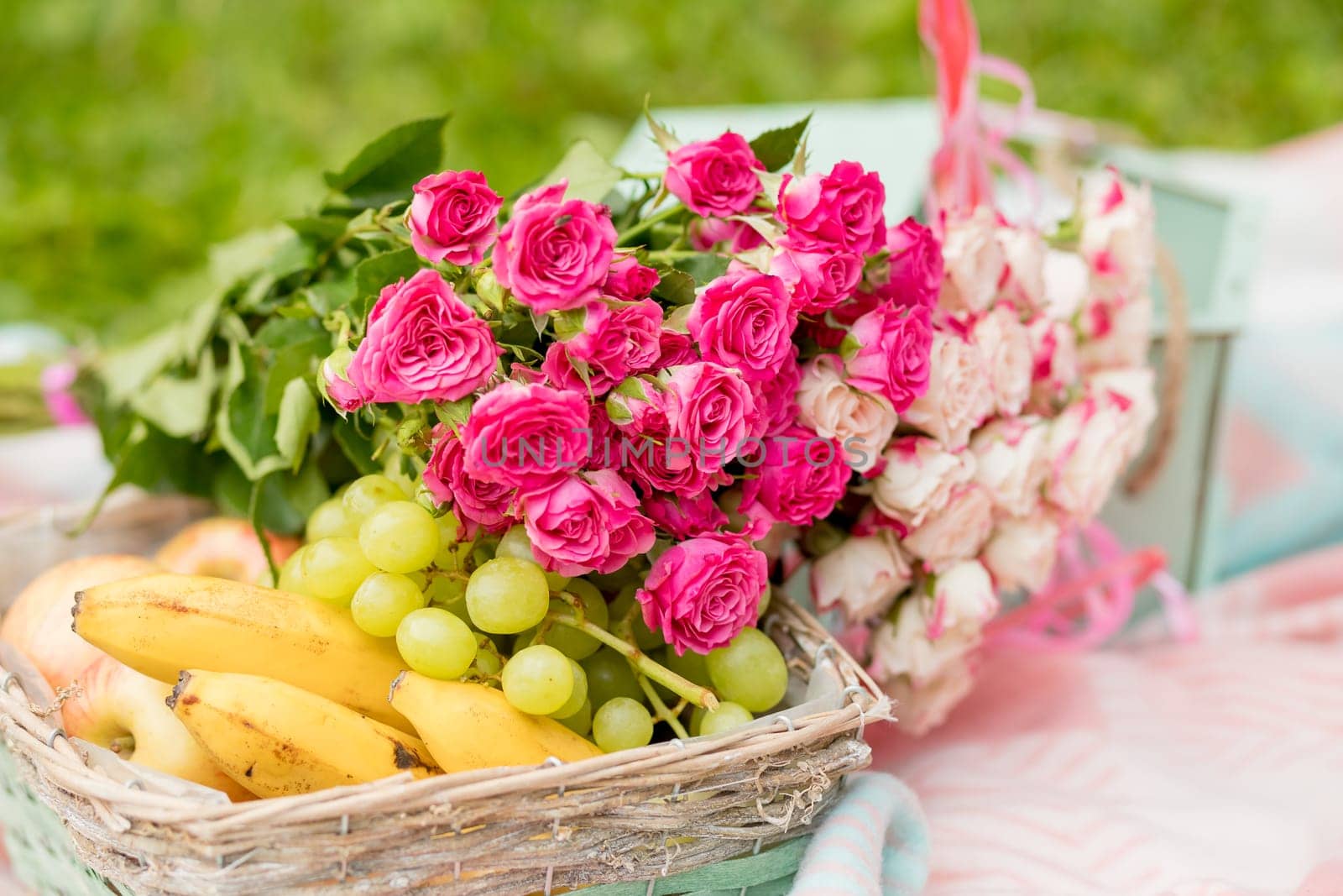 Bunch of fruits and flowers in a basket.Fruit gift basket. Present. Premium fruit. Gift concept