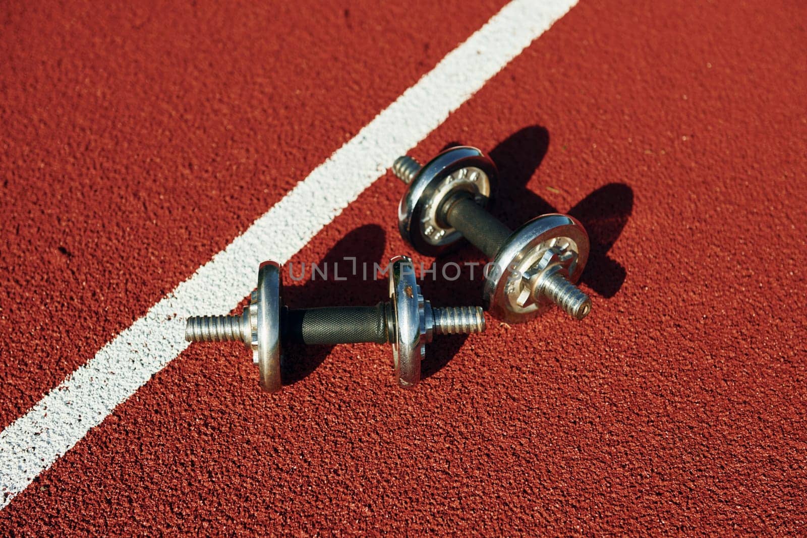 Top view of dumbbells that is on the ground by Standret