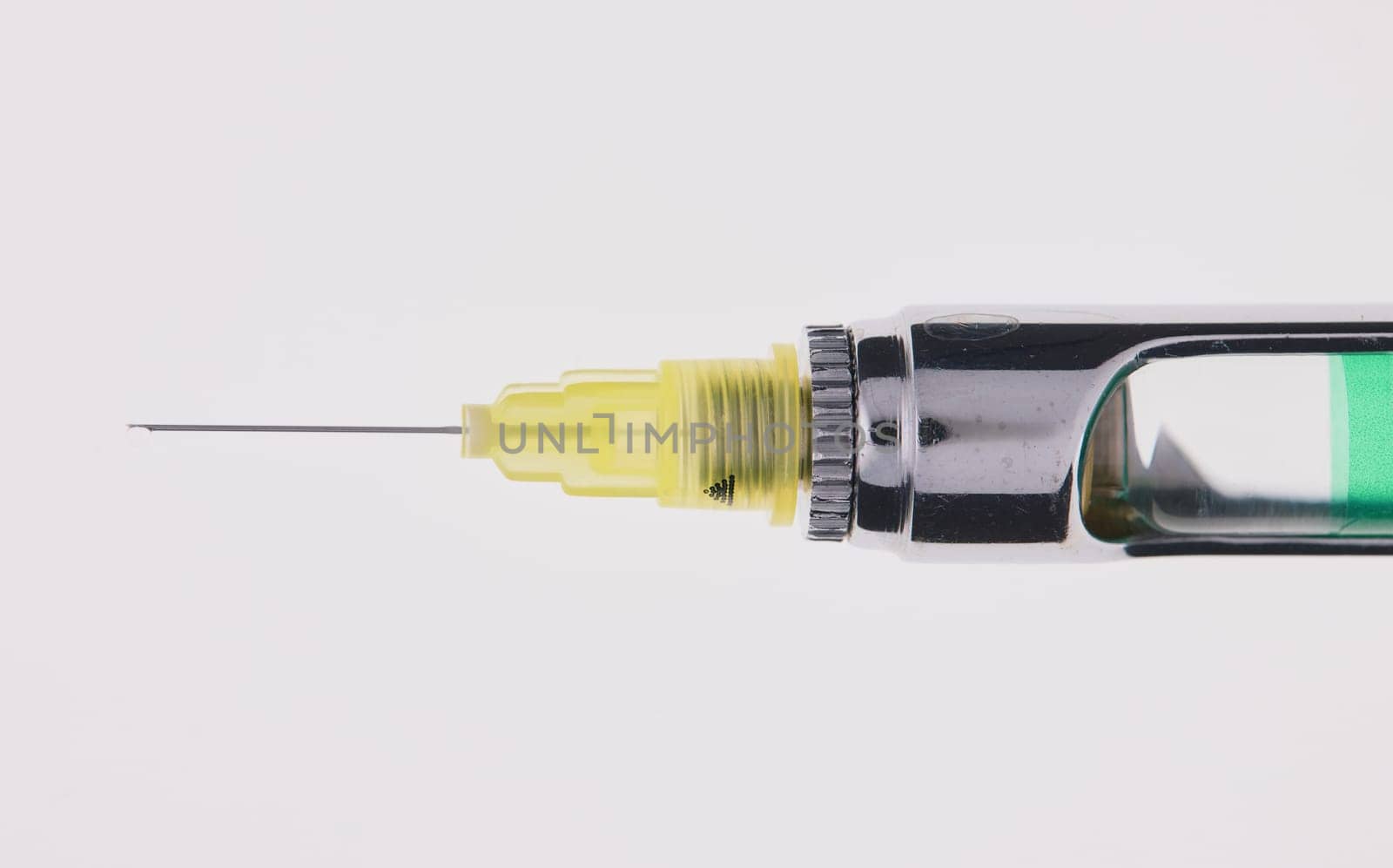 Steel dental syringe for local anesthesia, isolated on white. Carpool syringe for anesthesia in dentistry. Thin needle on a syringe for anesthesia in dentistry.