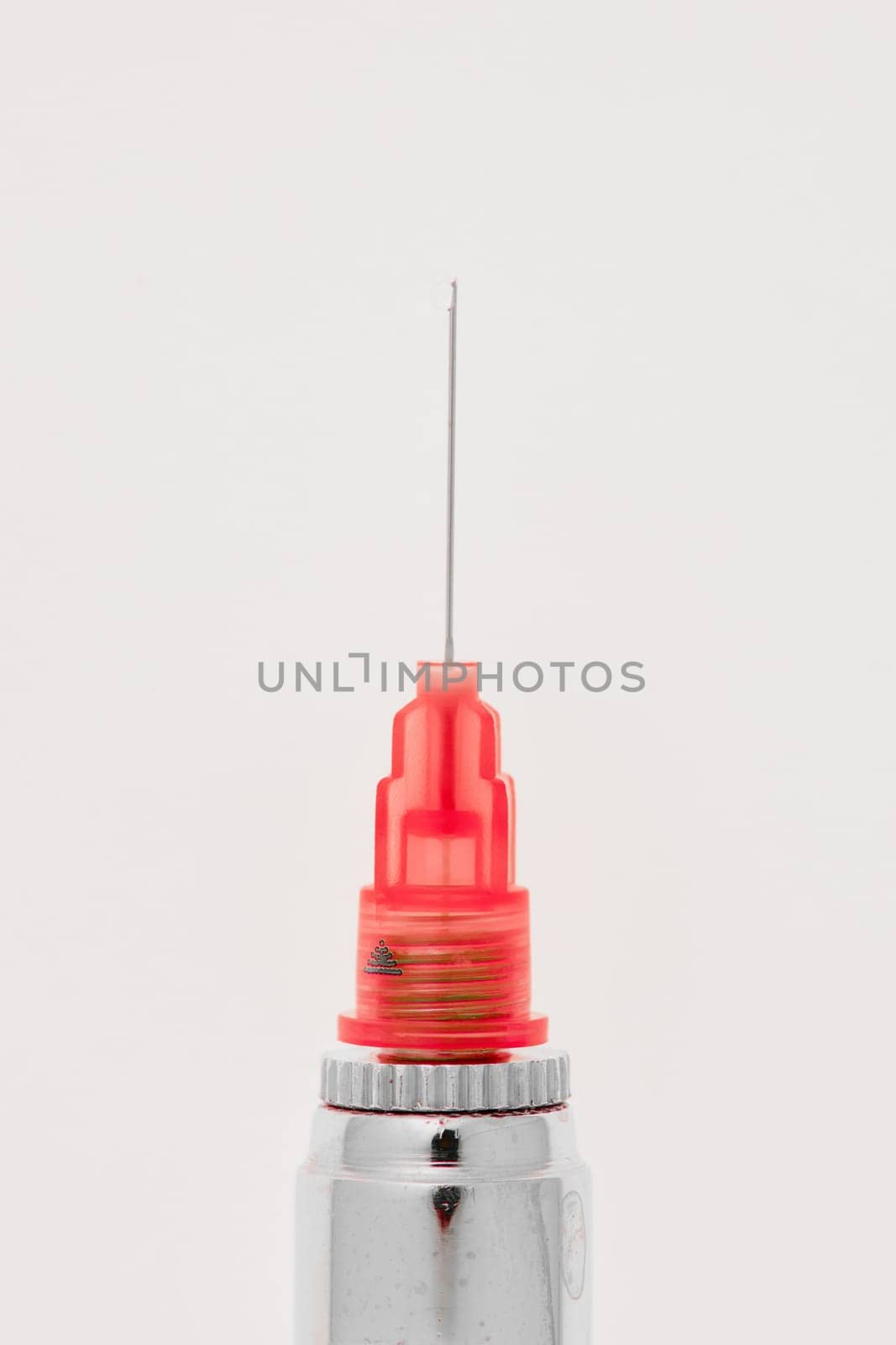 Steel dental syringe for local anesthesia, isolated on white. Carpool syringe for anesthesia in dentistry. Thin needle on a syringe for anesthesia in dentistry.