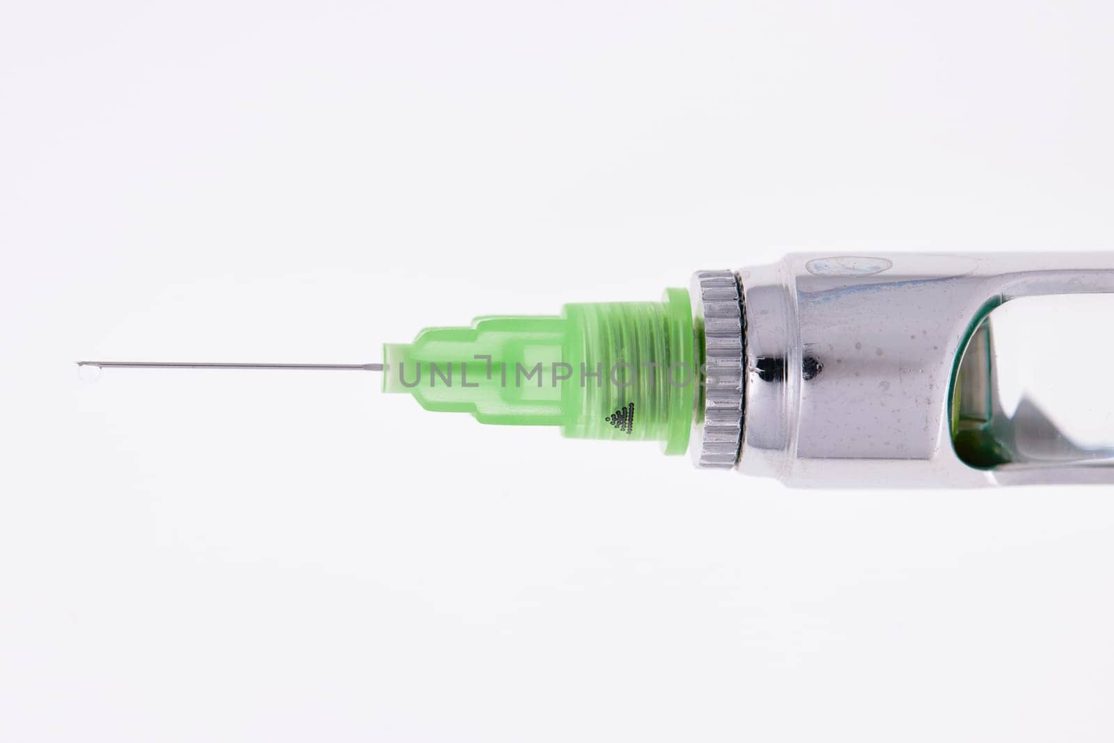 Steel dental syringe for local anesthesia, isolated on white. Carpool syringe for anesthesia in dentistry. Thin needle on a syringe for anesthesia in dentistry.