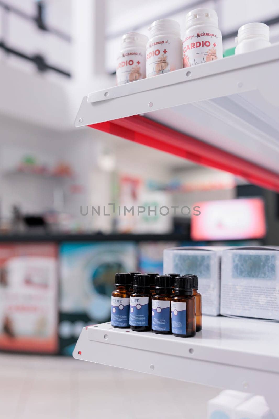 Selective focus of empty health care facility filled with shelves full with essential oil by DCStudio