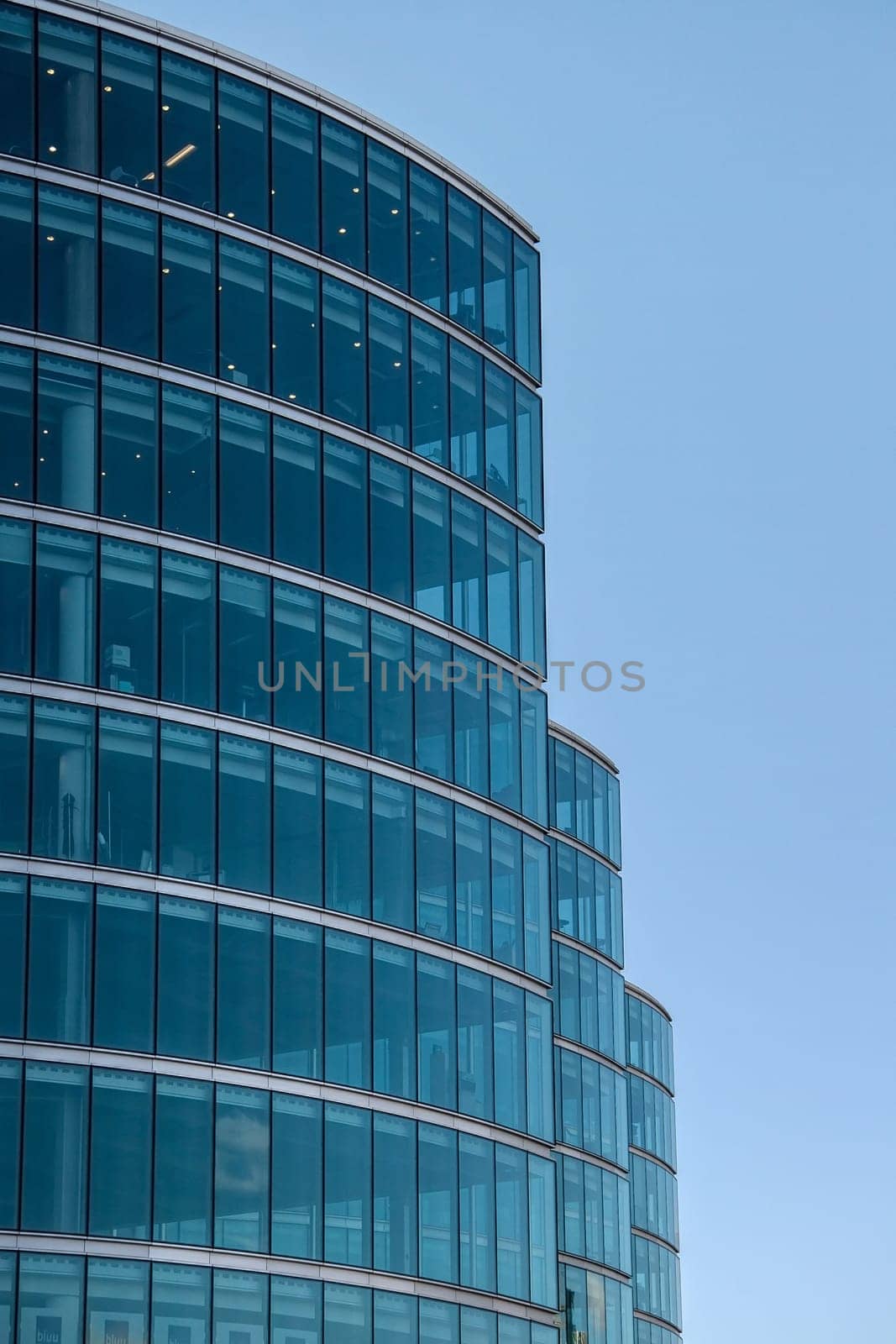 London, United Kingdom - December 03, 2006: Blue glass windows on offices ("More London Estates" design by Foster and Partners) clear sky in background. Example of modern architecture in UK capital