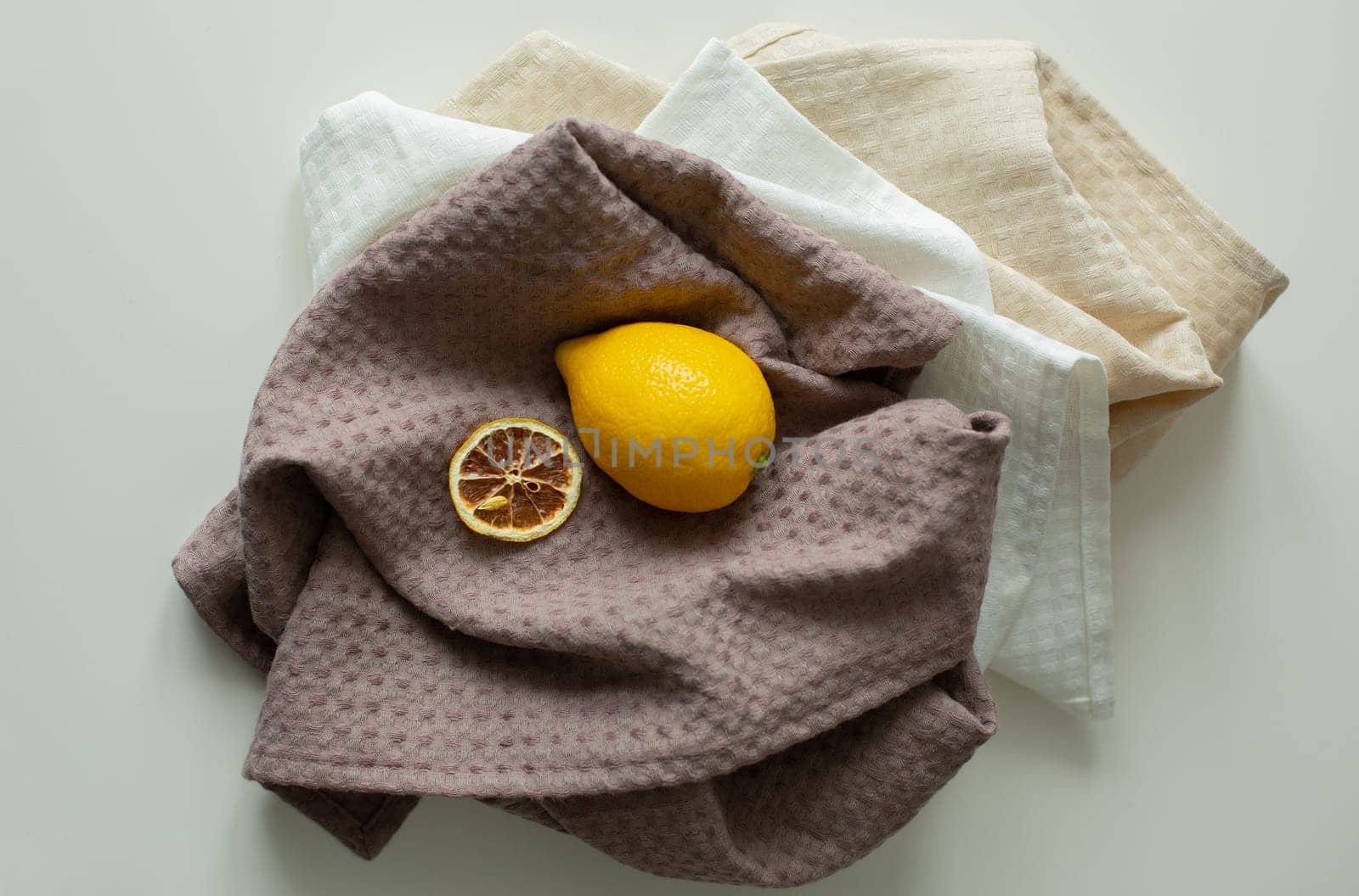 There are linen towels on the table, with lemon and candied fruits on them.