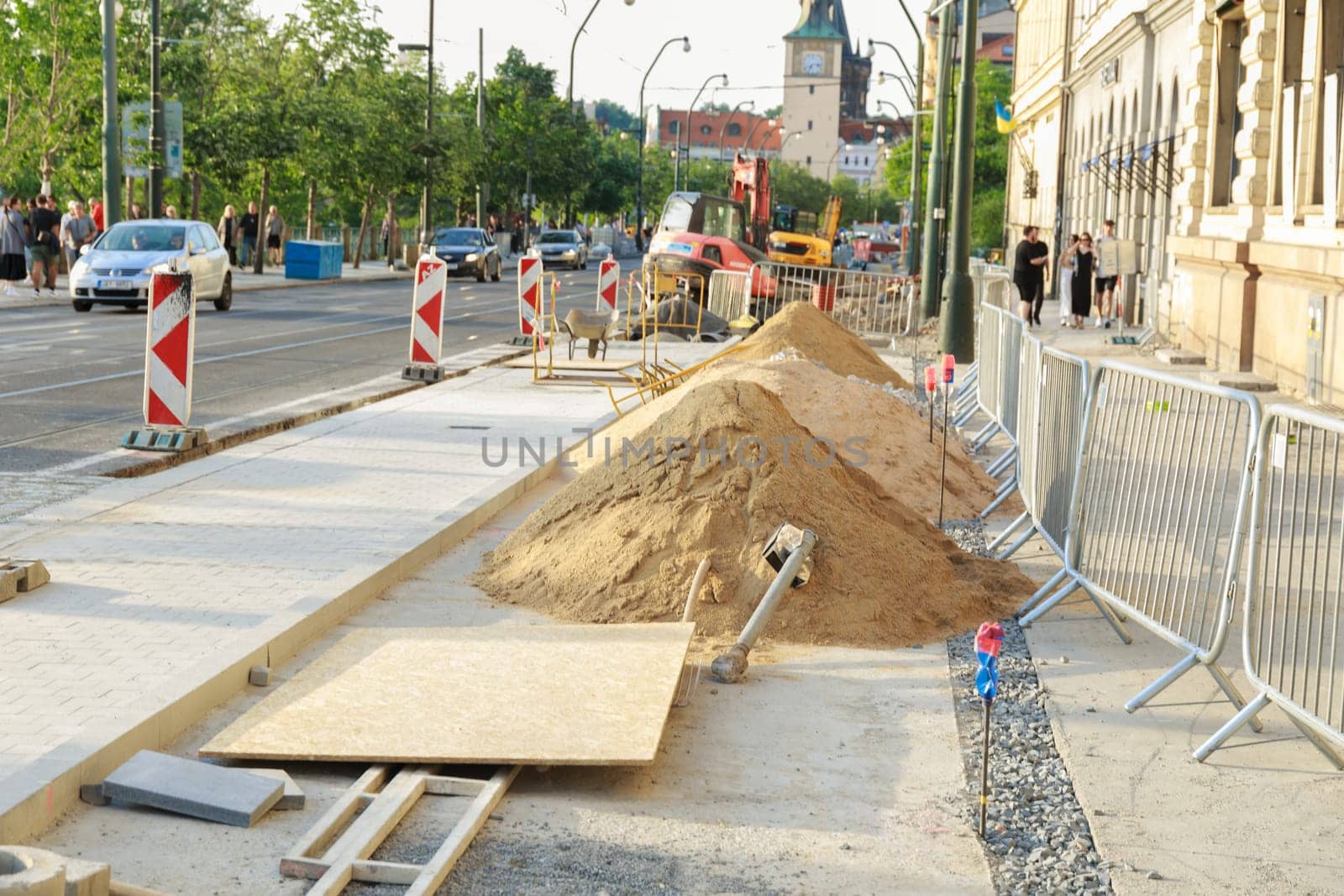 22 May 2022 Prague, Czech Republic. A pile of sand and construction materials on the sidewalk in the city of Prague. Repair works of the pedestrian area near the road are being carried out.