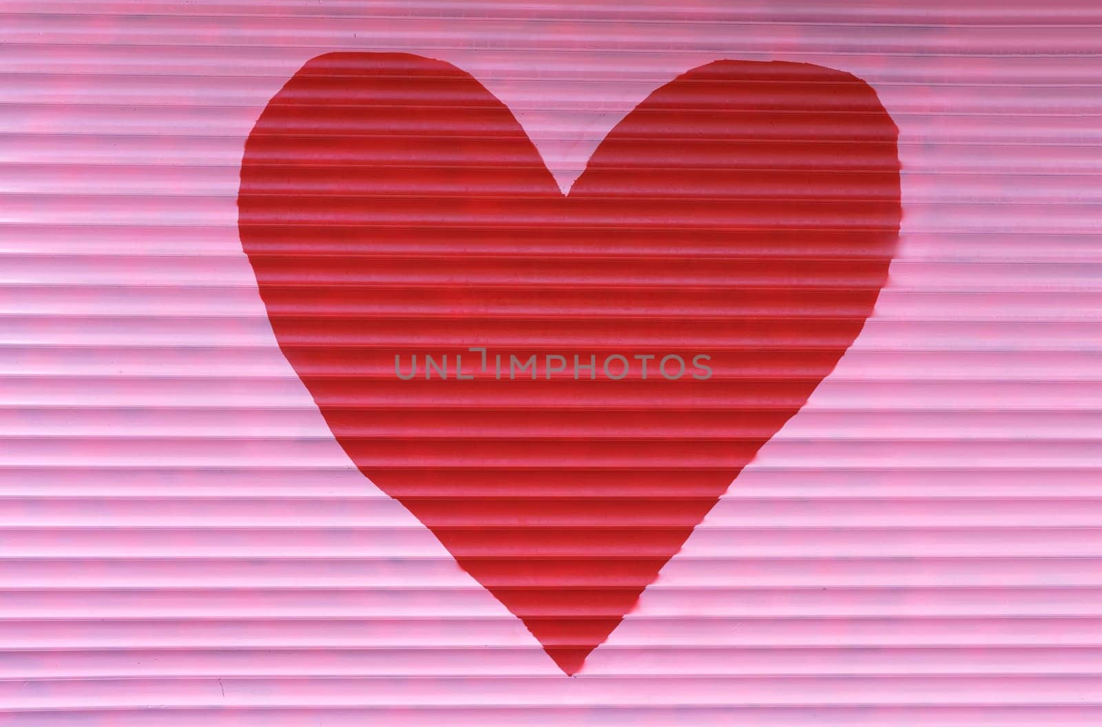 A large red heart is painted on the pink blinds. Background, texture for Valentine's Day.