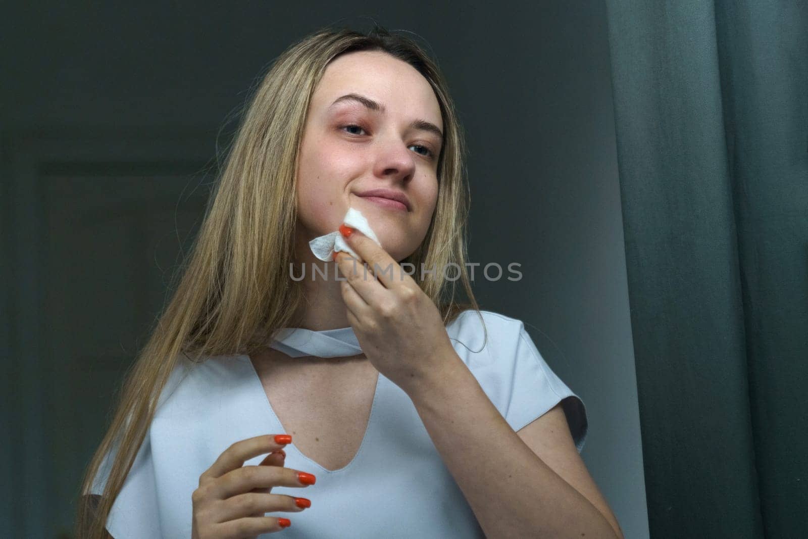 Young woman cleans her face with napkins. by Sd28DimoN_1976
