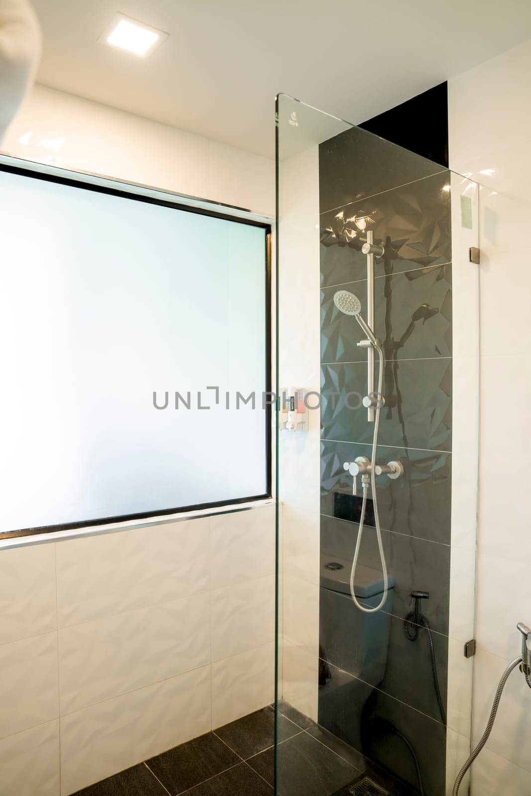 A minimalistic bathroom and shower by Gamjai
