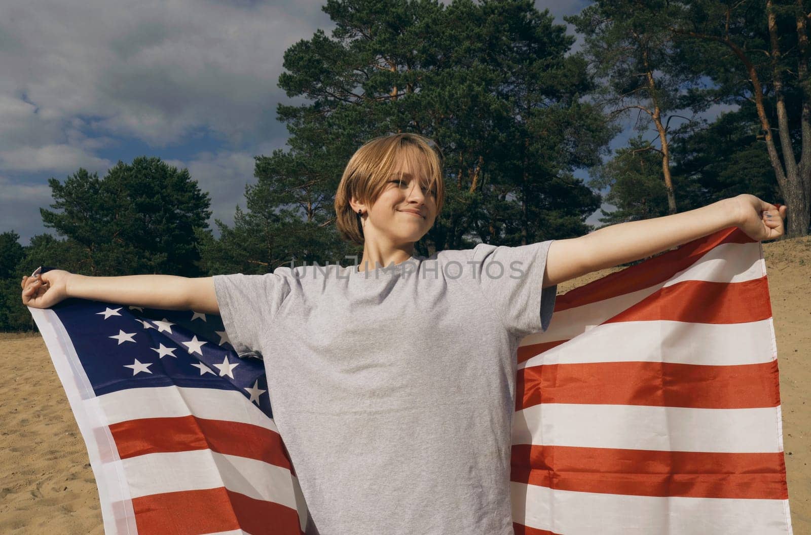 American flag - woman USA sport athlete winner cheering waving stars and stripes outdoor after in desert nature. by Sd28DimoN_1976