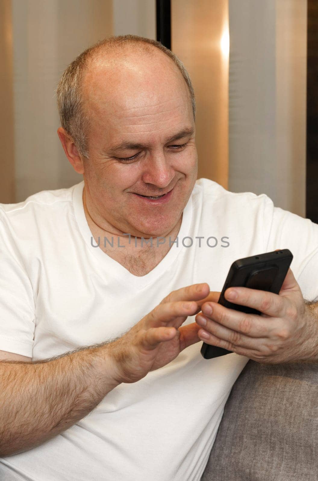 A man sits on the couch and browses social networks and videos by Sd28DimoN_1976