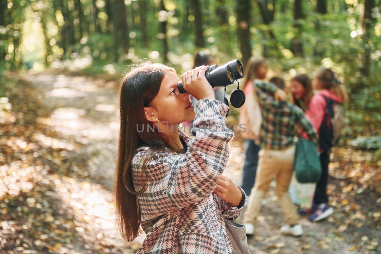 Discovering new places. Kids in green forest at summer daytime together.