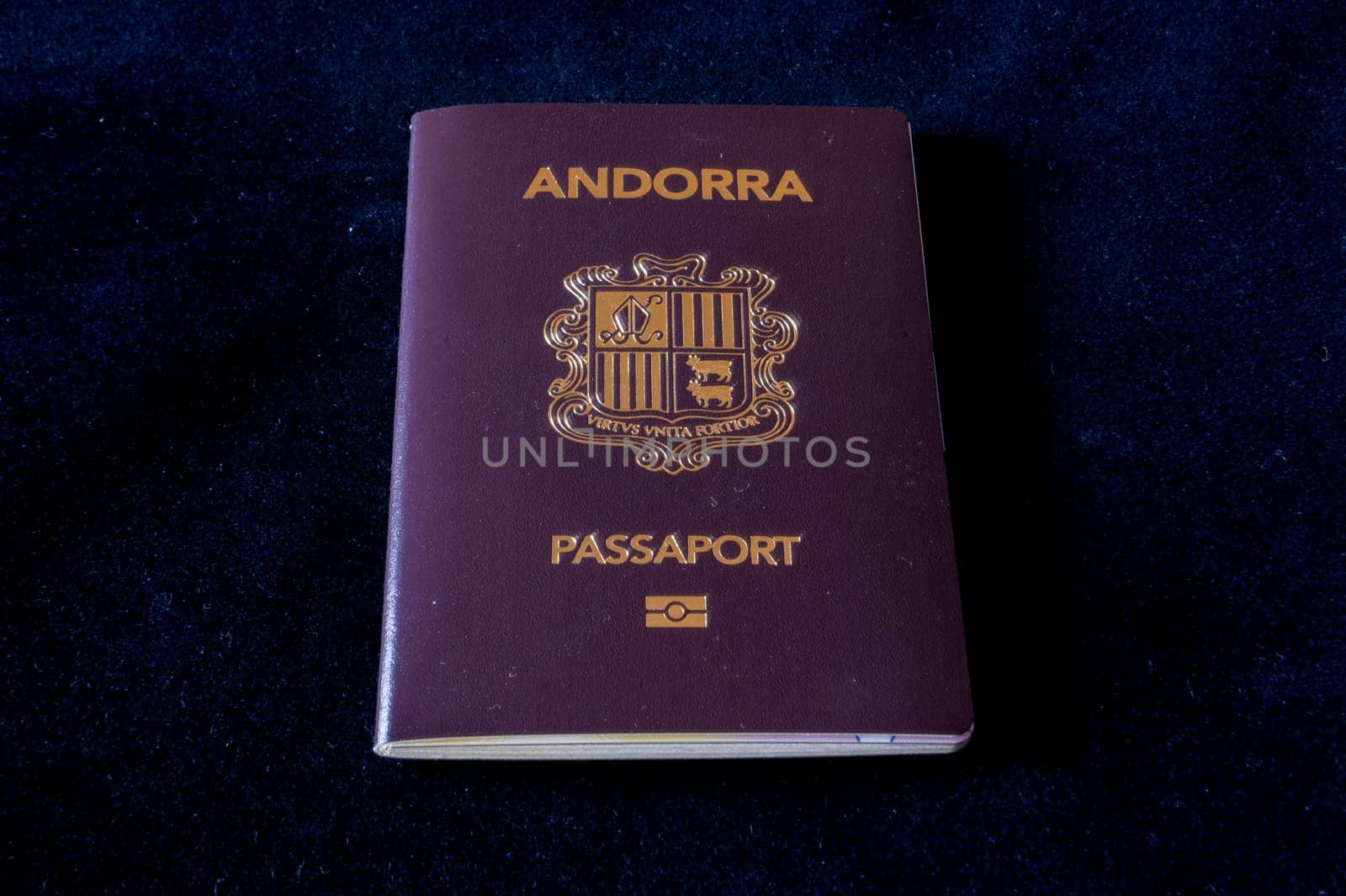 Passport of the Principality of Andorra on a black background by martinscphoto