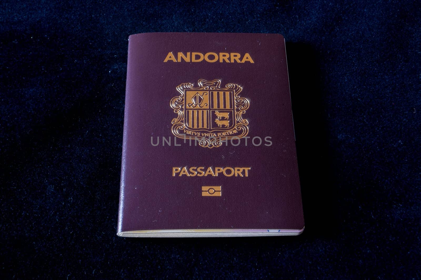 Passport of the Principality of Andorra on a black background.