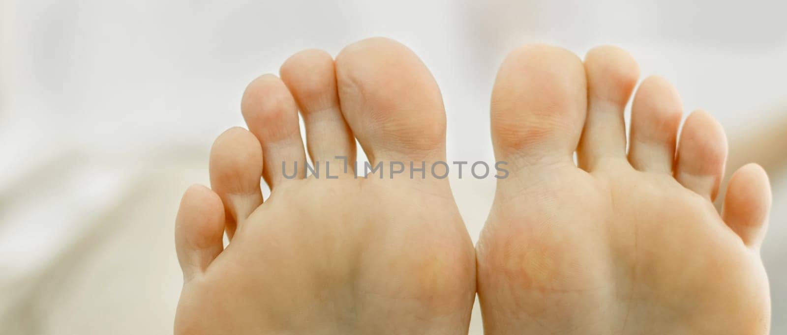 Two feet of a woman pressed against each other. Toes close-up, foot partially visible. by Sd28DimoN_1976