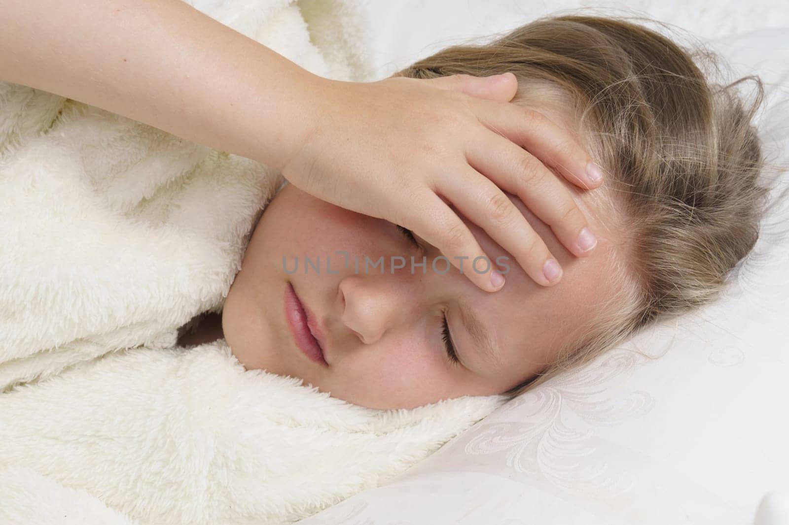 A sick teenage girl clings to her head. Medical concept.