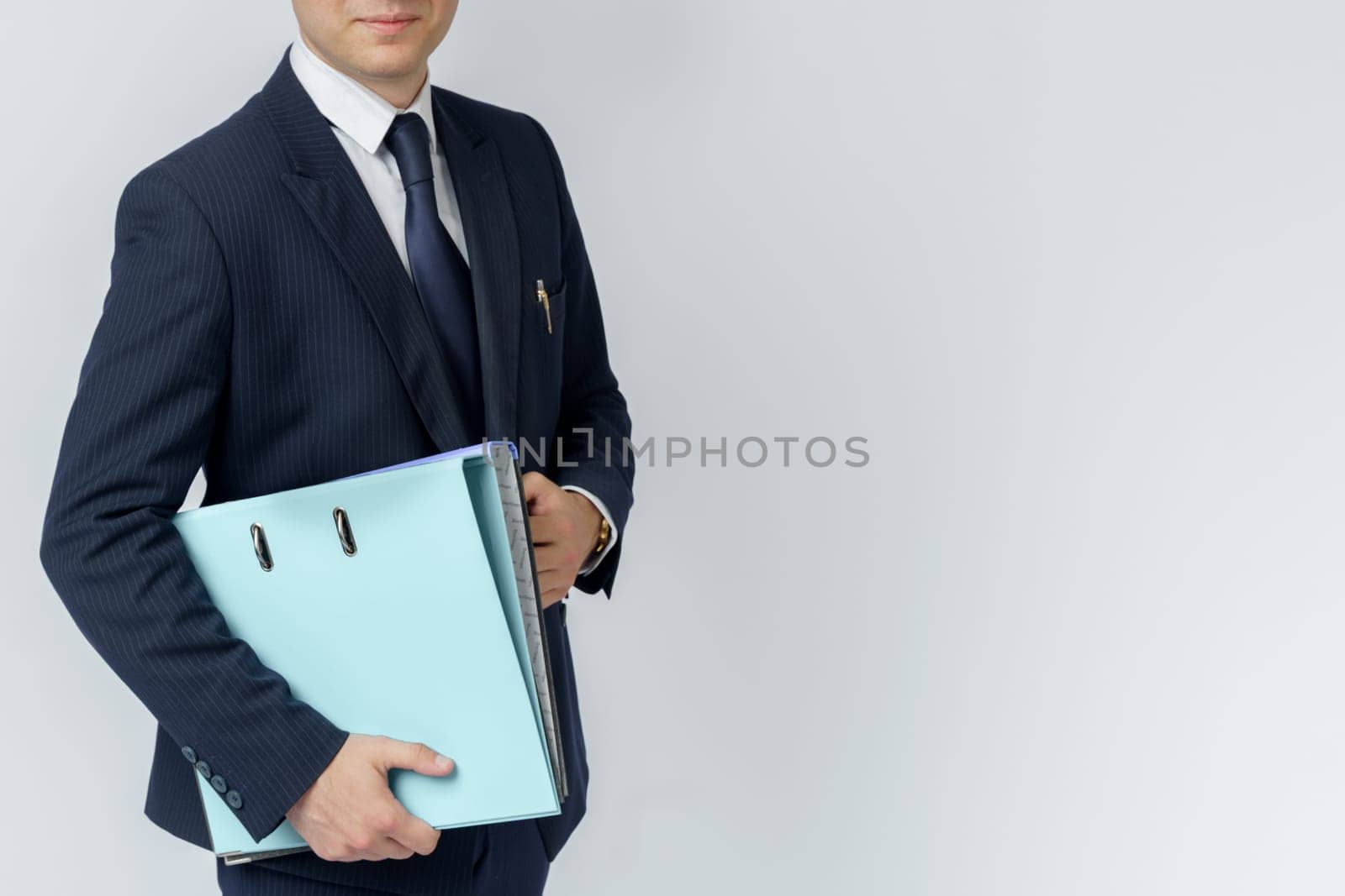 Businessman in a blue suit holds a folder in his hands on a white background. No face visible. Business and finance concept by Sd28DimoN_1976