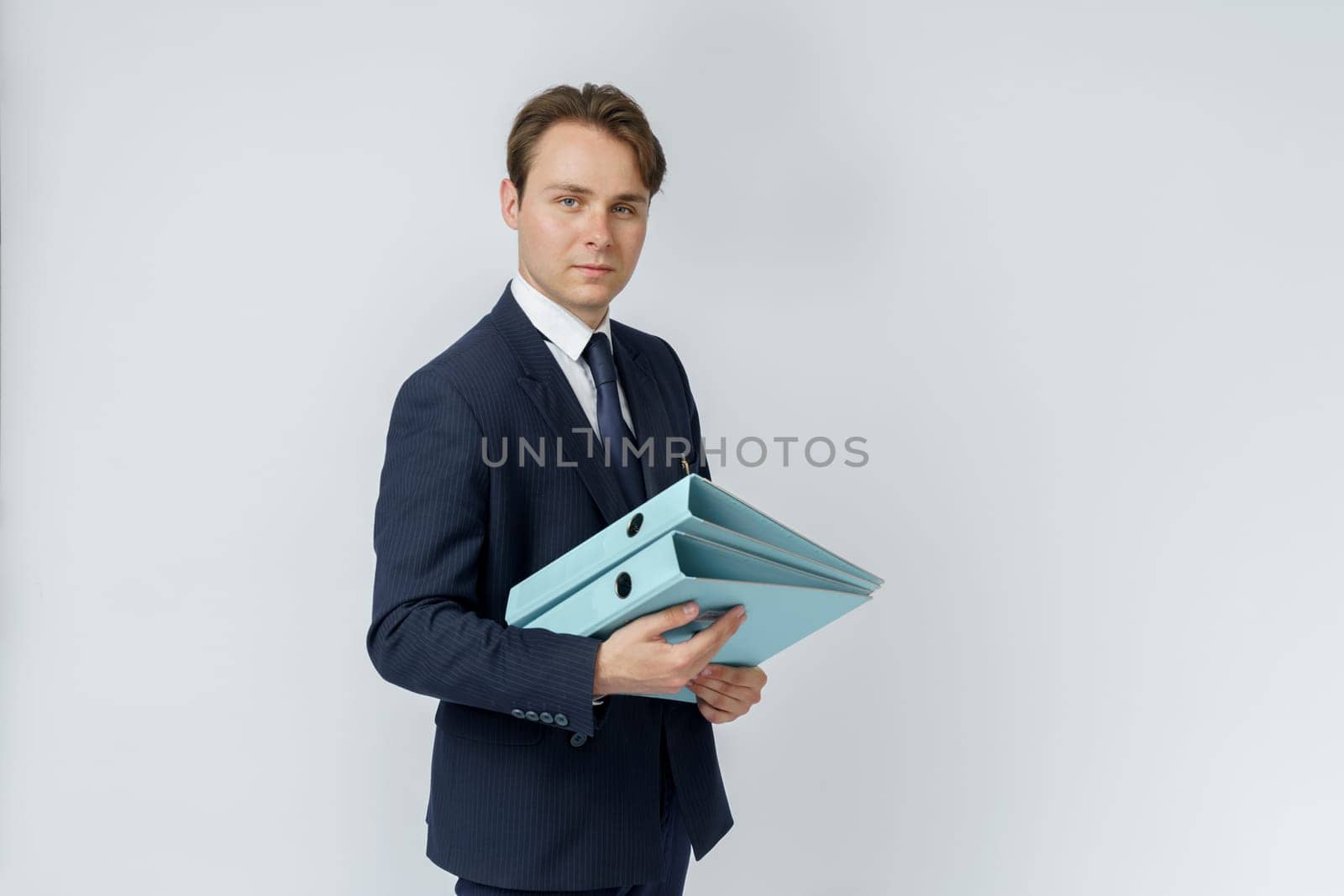 A businessman in a blue suit holds folders on a white background. by Sd28DimoN_1976