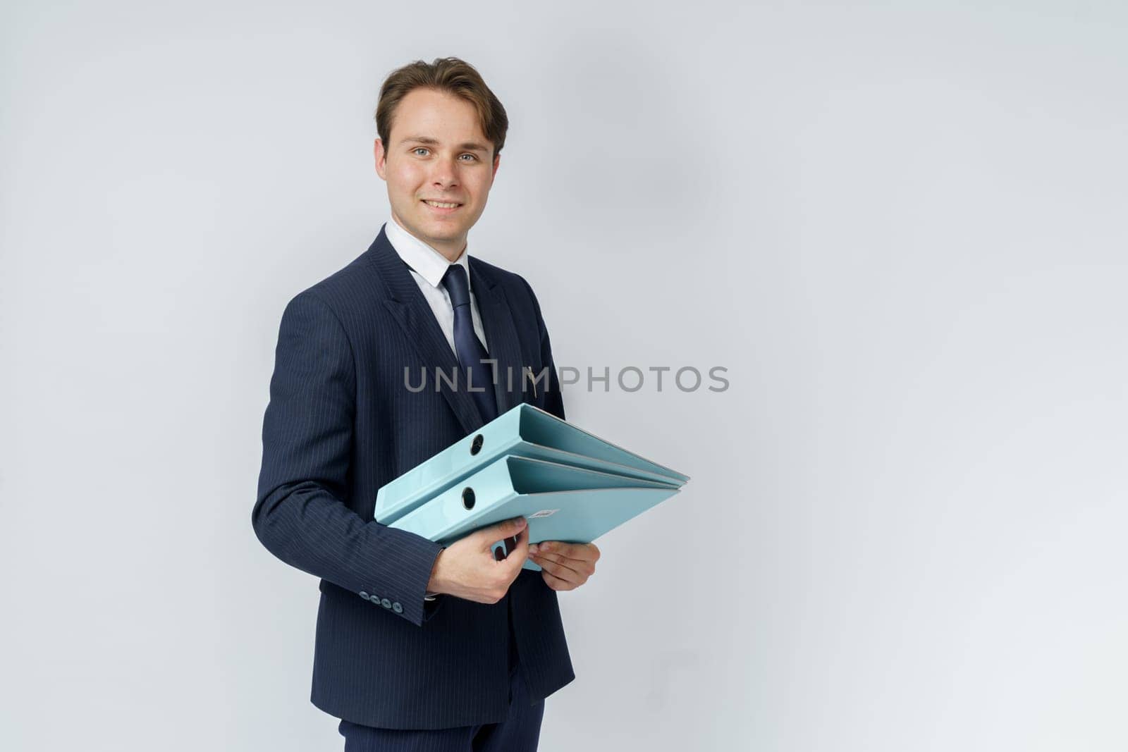 A businessman in a blue suit holds folders on a white background. by Sd28DimoN_1976